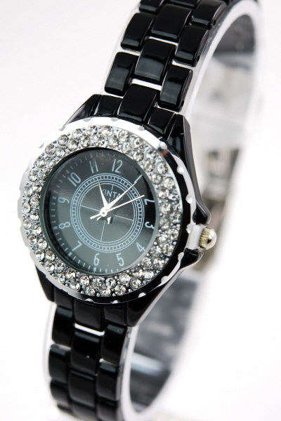 A stylish metal band watch with a 2 1/2 inch diameter, showcasing its elegant design and comfortable fit.