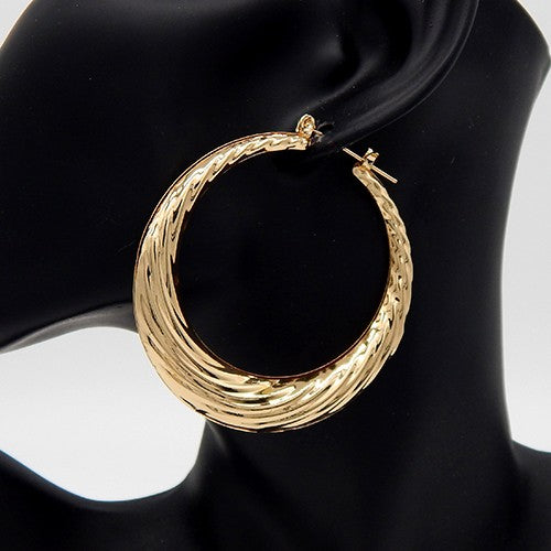 Elegant wave texture bamboo hoop earrings, lightweight and polished, measuring 3 inches in diameter.