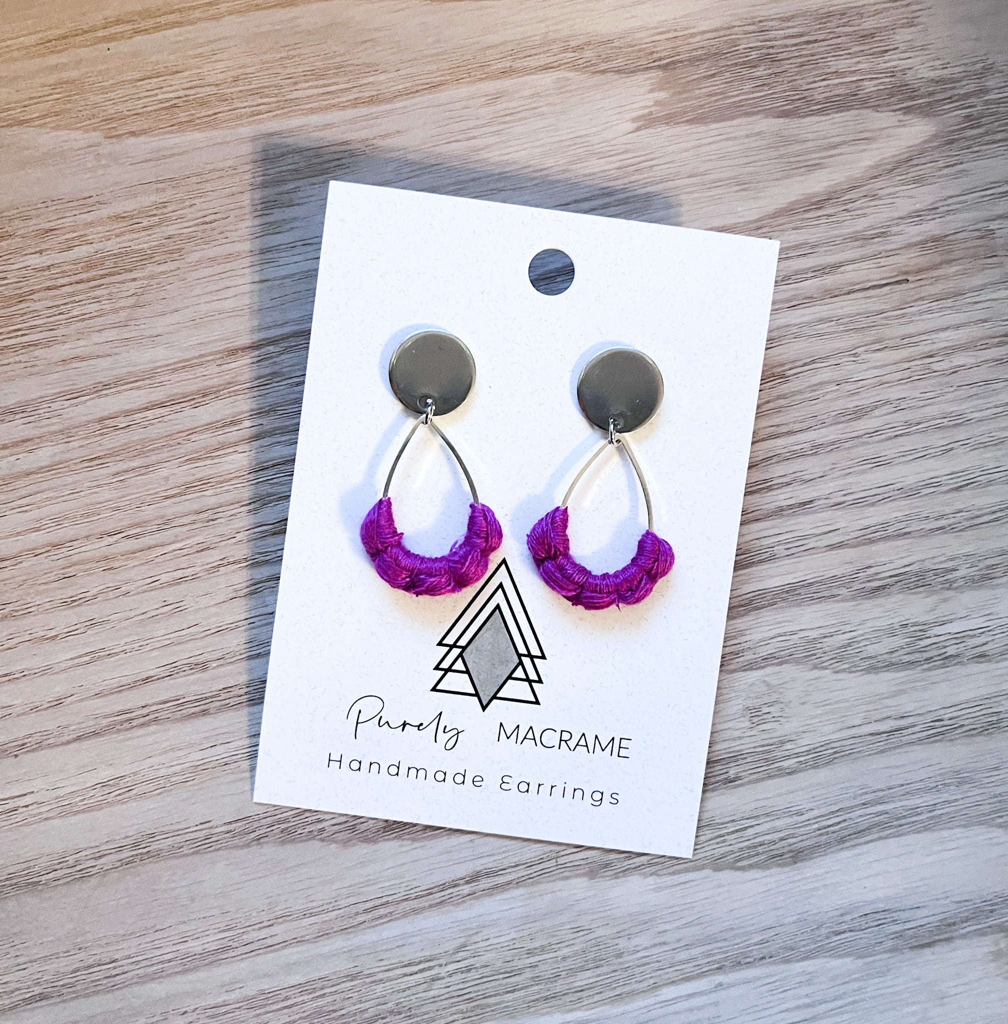 A pair of lightweight Winter Fuchsia Studs made from 100% cotton, showcasing a vibrant fuchsia color.