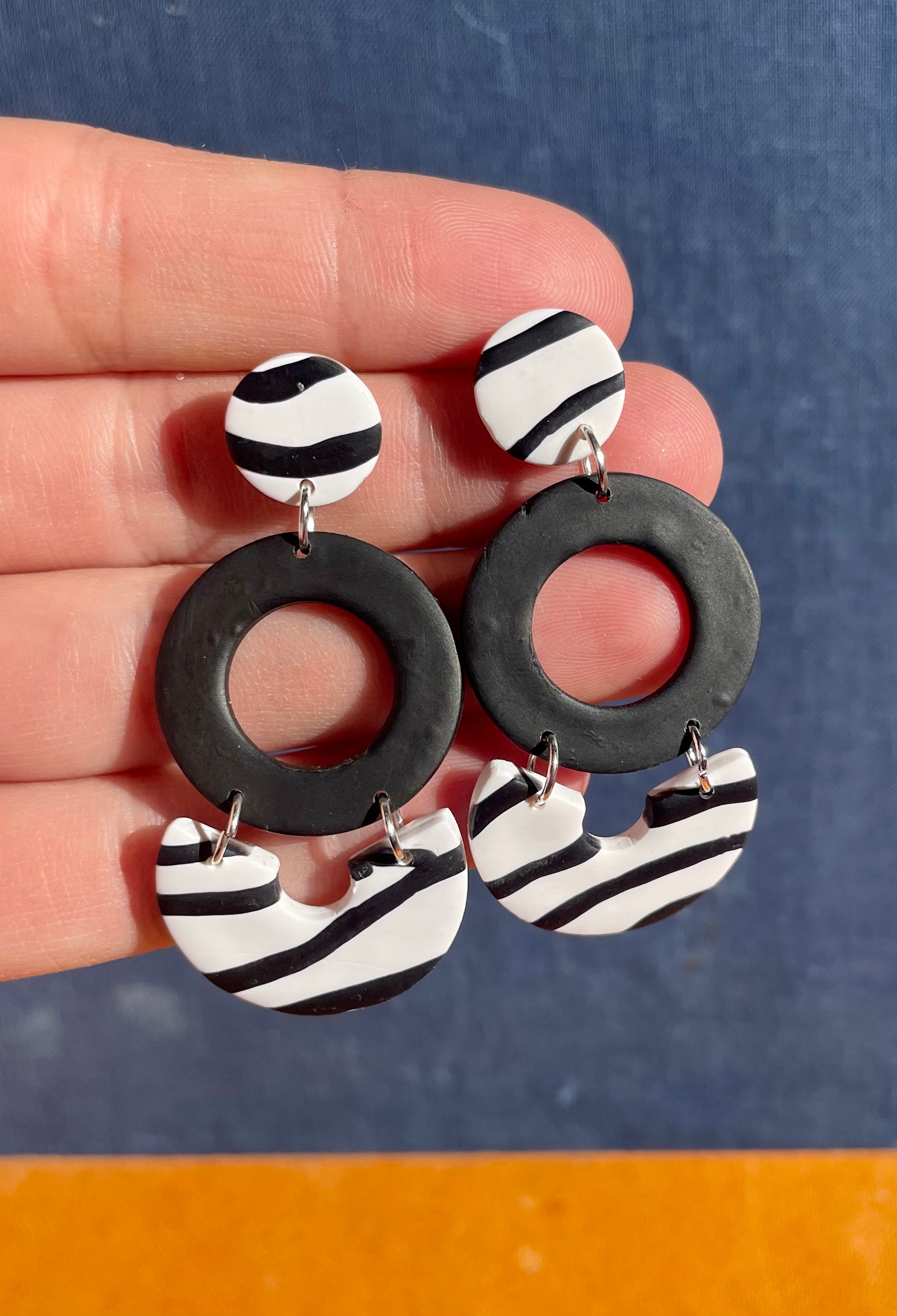 Handmade zebra dangle earrings featuring unique patterns and lightweight design, perfect for any occasion.