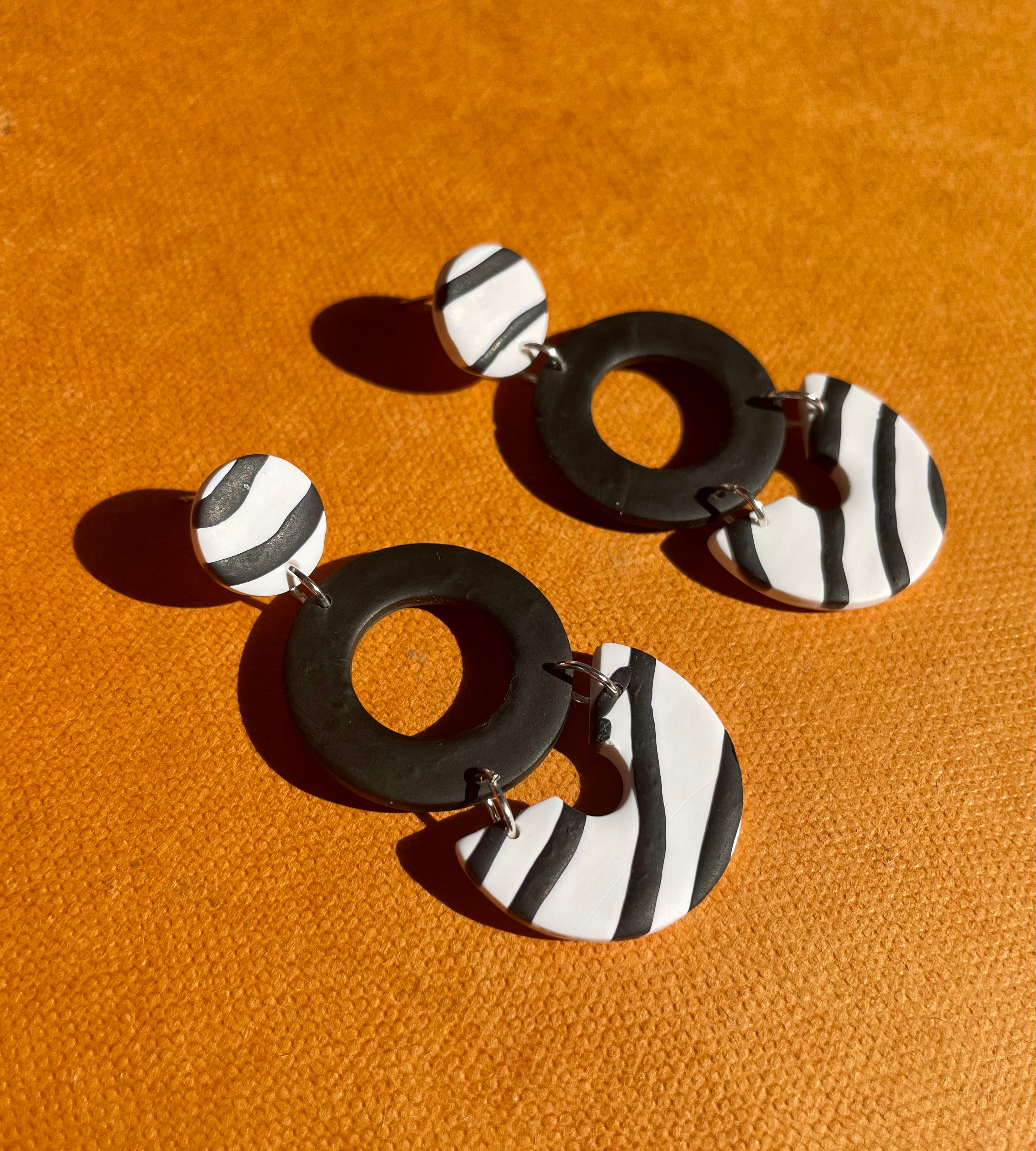 Handmade zebra dangle earrings featuring unique patterns and lightweight design, perfect for any occasion.