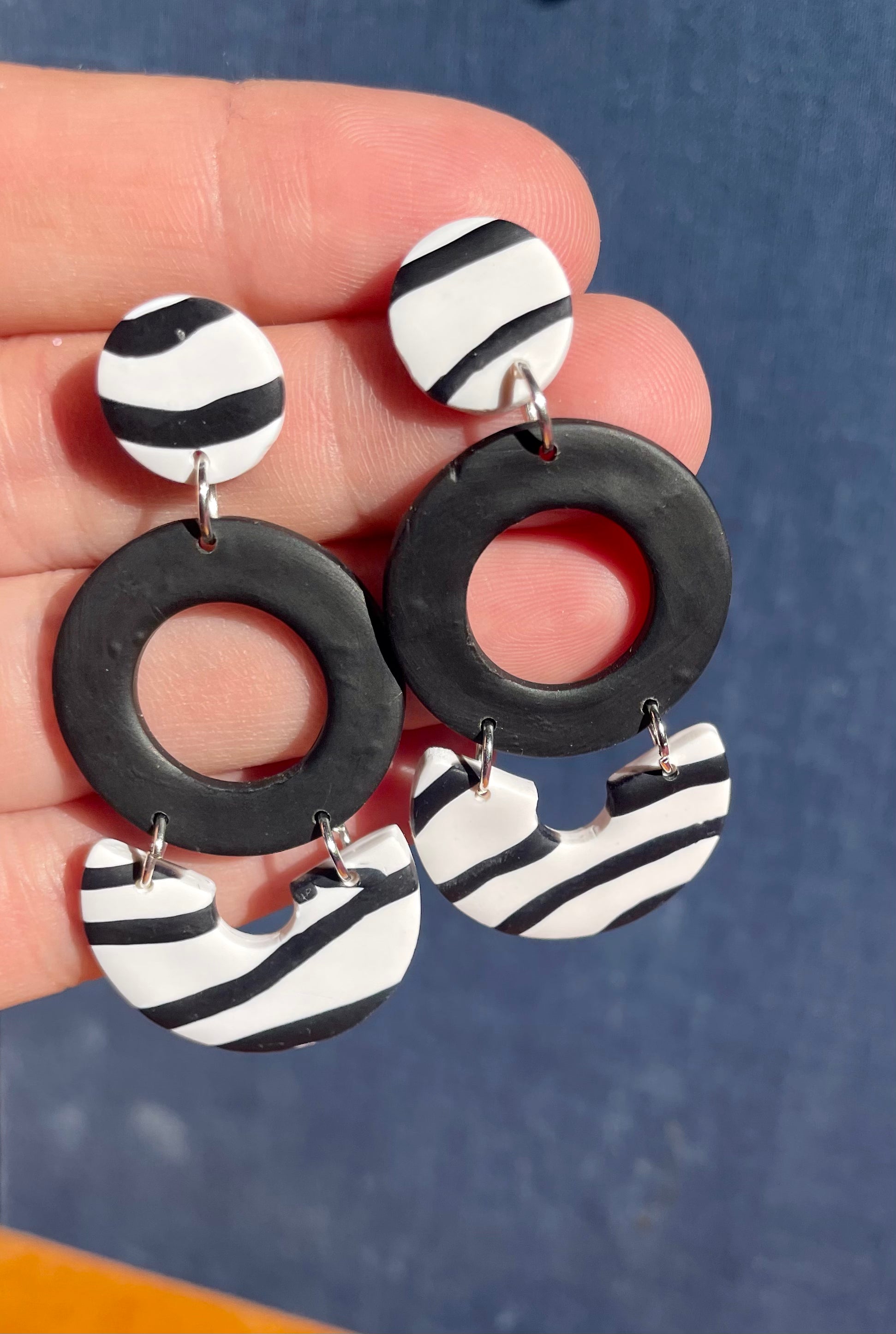 Handmade zebra dangle earrings featuring unique patterns and lightweight design, perfect for any occasion.