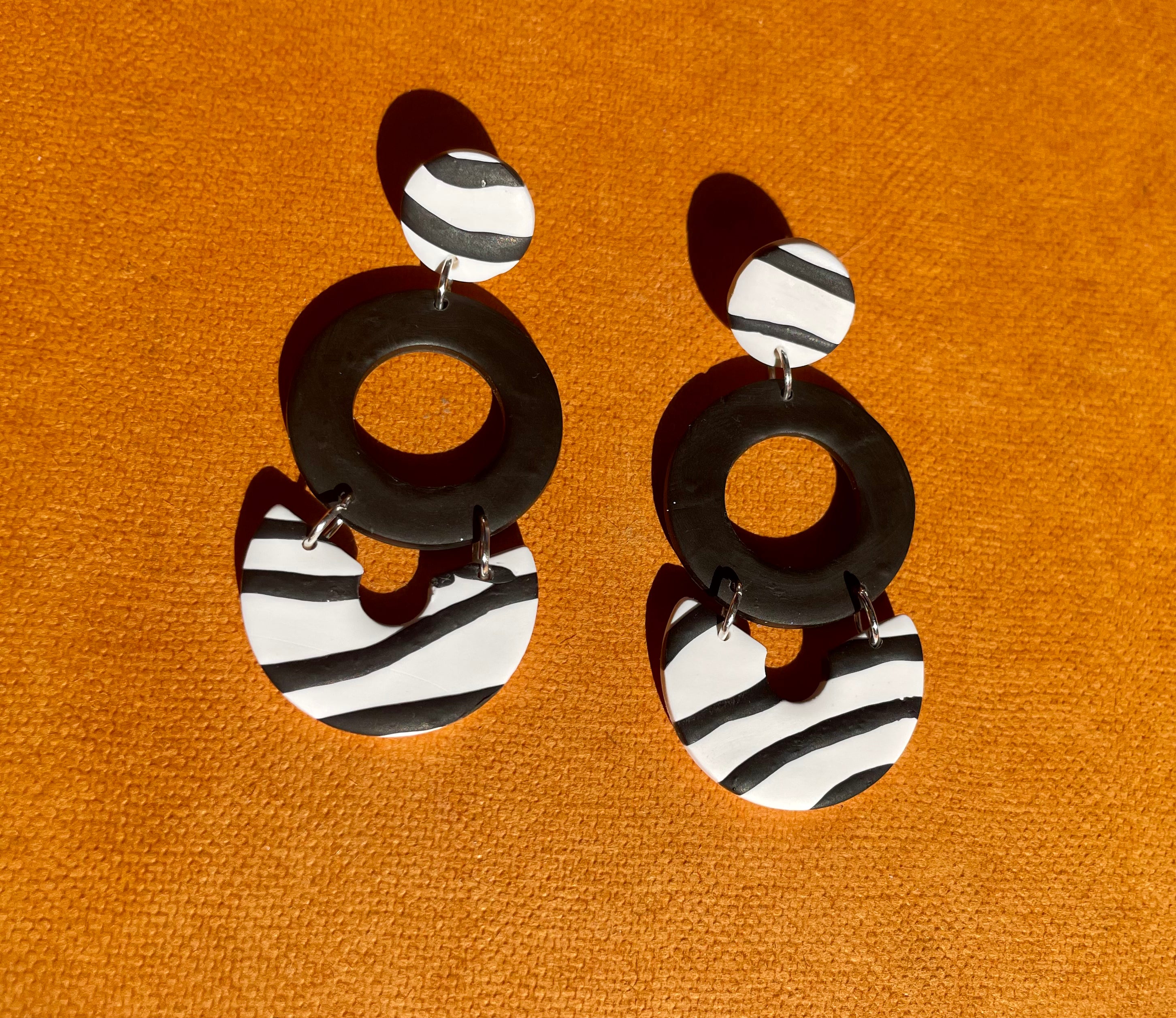 Handmade zebra dangle earrings featuring unique patterns and lightweight design, perfect for any occasion.