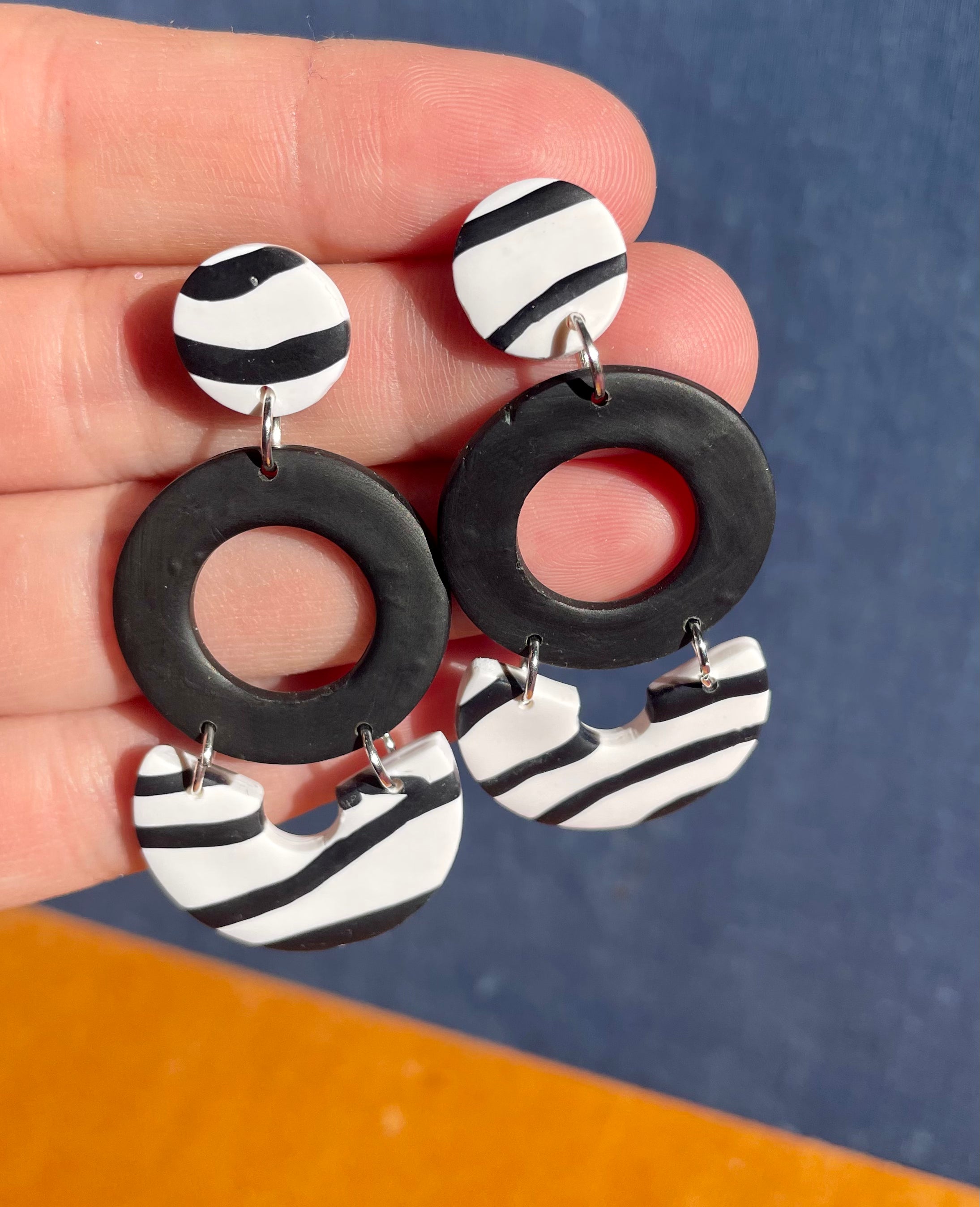 Handmade zebra dangle earrings featuring unique patterns and lightweight design, perfect for any occasion.