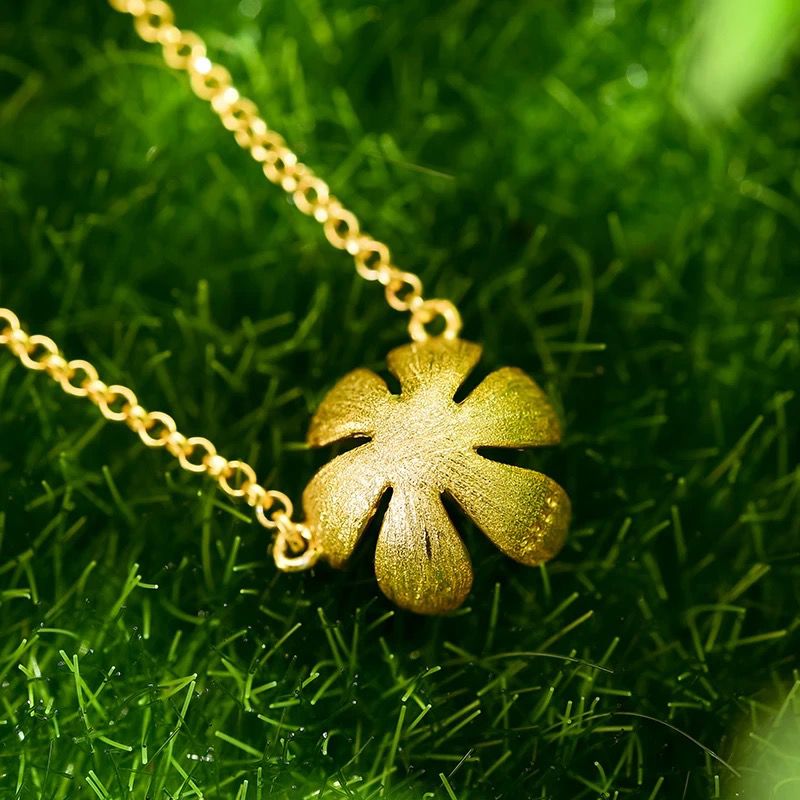 Adonis Necklace featuring a sterling silver chain and an 18K gold-plated pomegranate pendant, showcasing intricate details and elegant design.