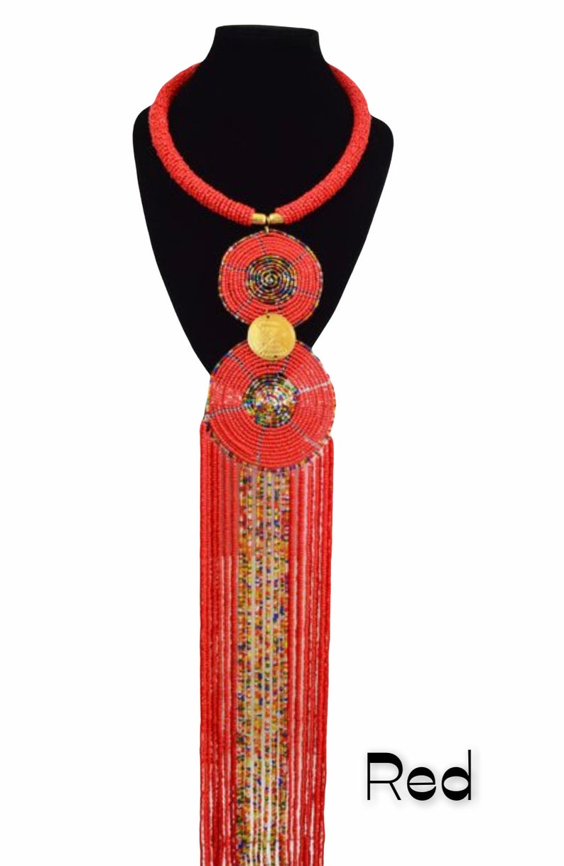 Handmade African pendant beaded necklace featuring vibrant colors and brass metal decoration, showcasing a long hanging fringe.