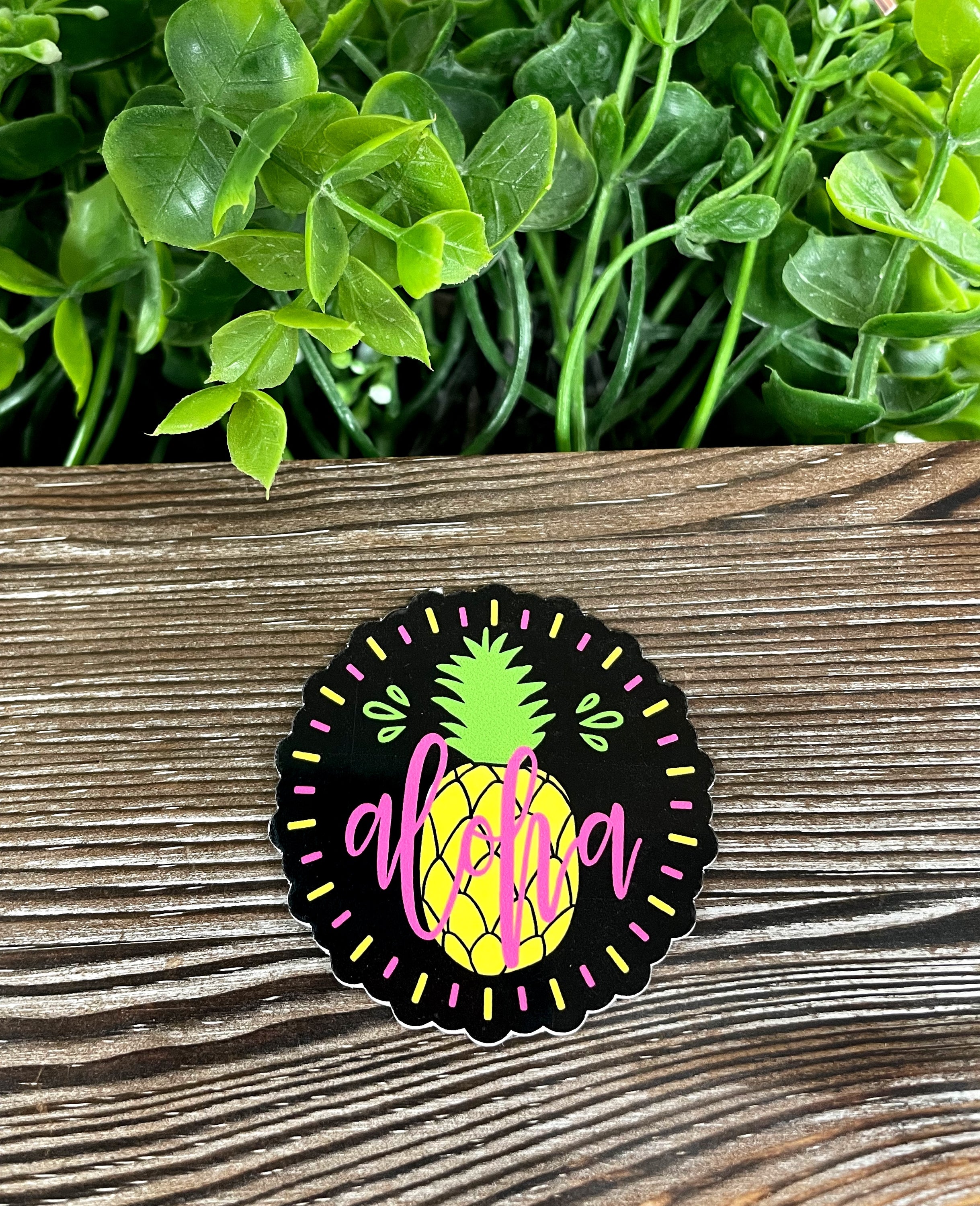 Aloha Pineapple Sticker featuring a vibrant pineapple design on a smooth surface, showcasing its water-resistant quality.