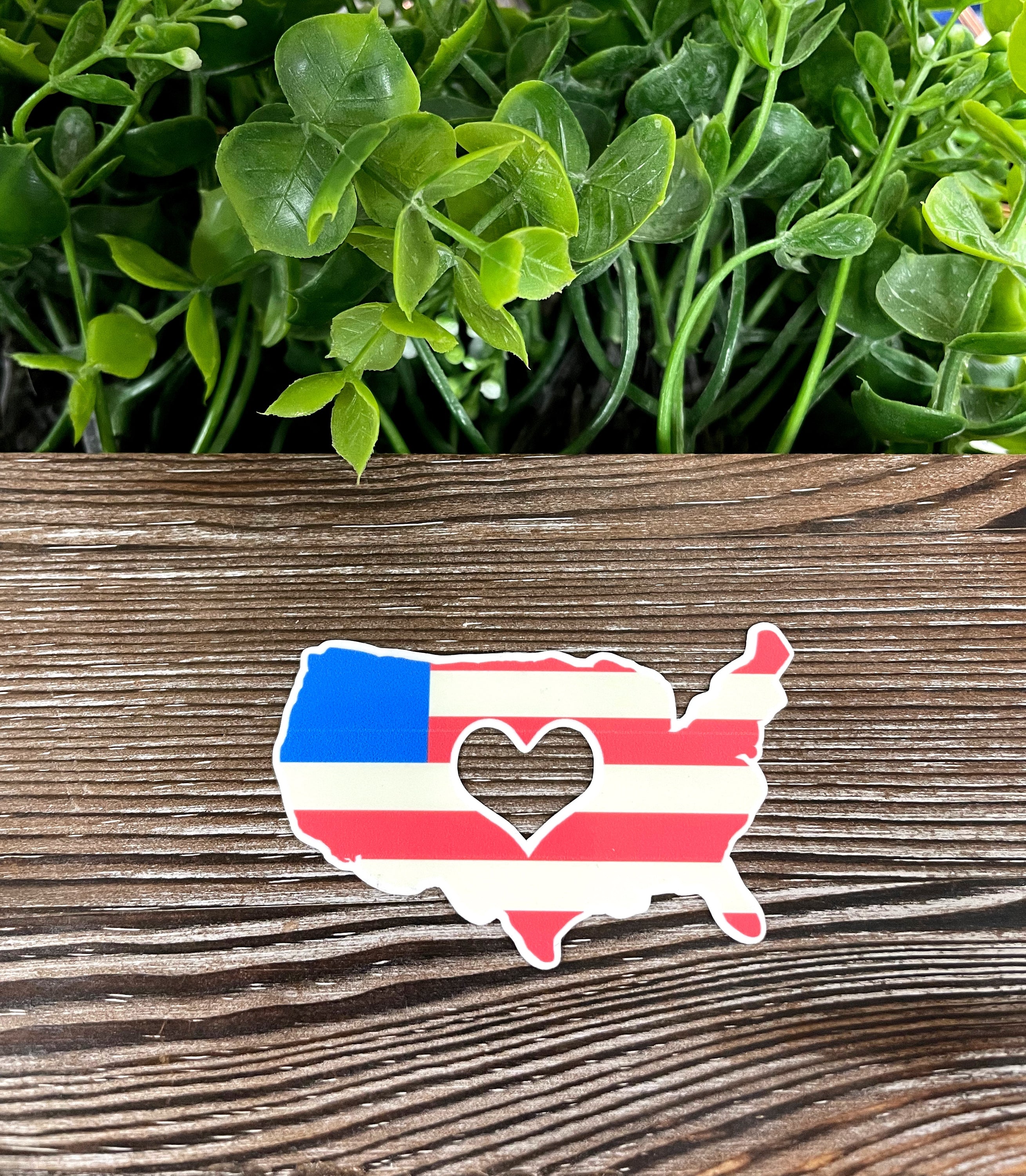 American Flag Heart Cut Out Sticker on a smooth surface, showcasing vibrant colors and unique design.