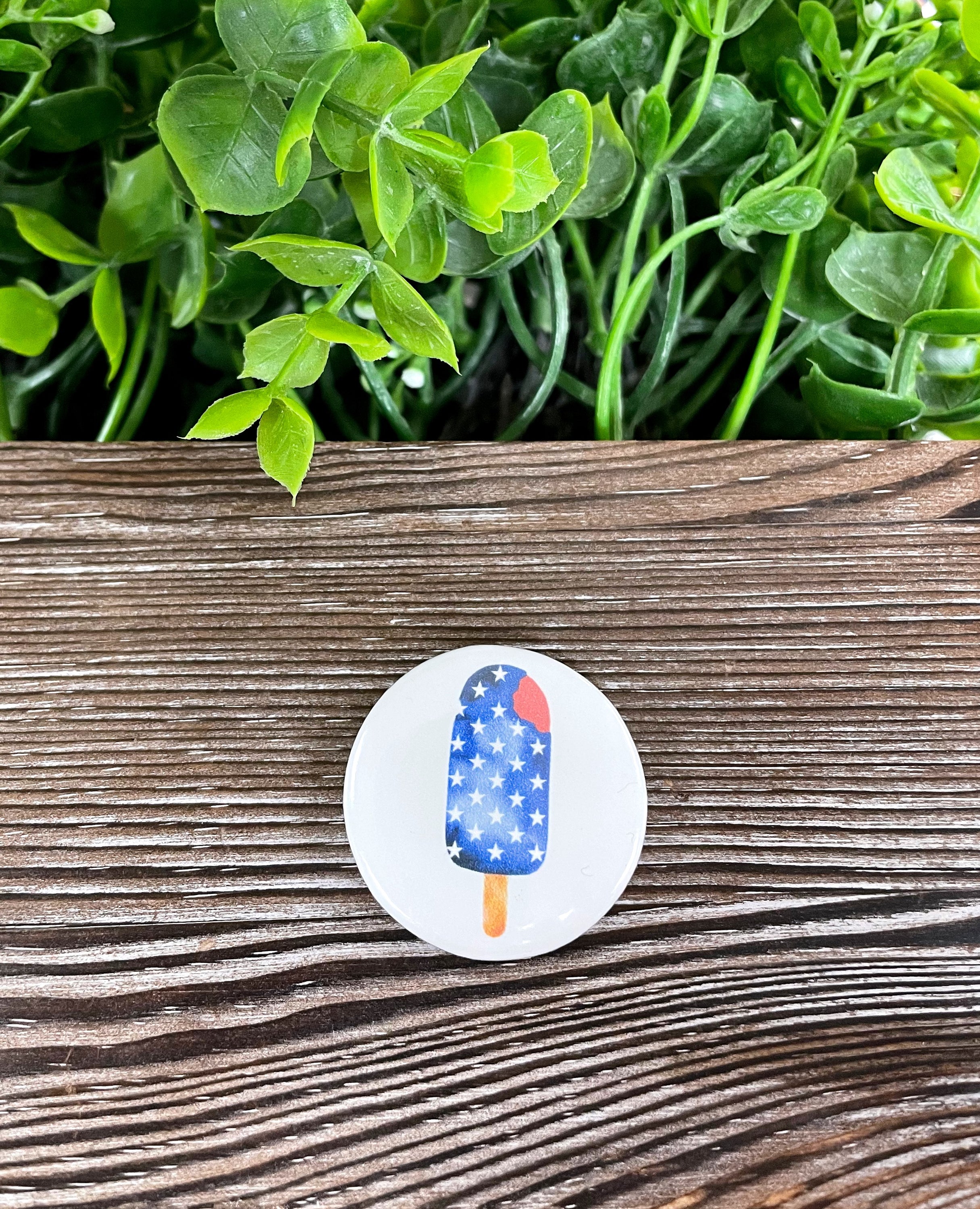 American Flag Popsicle graphic art button pin, 1.25 inches, featuring a vibrant blue color and a durable plastic back.