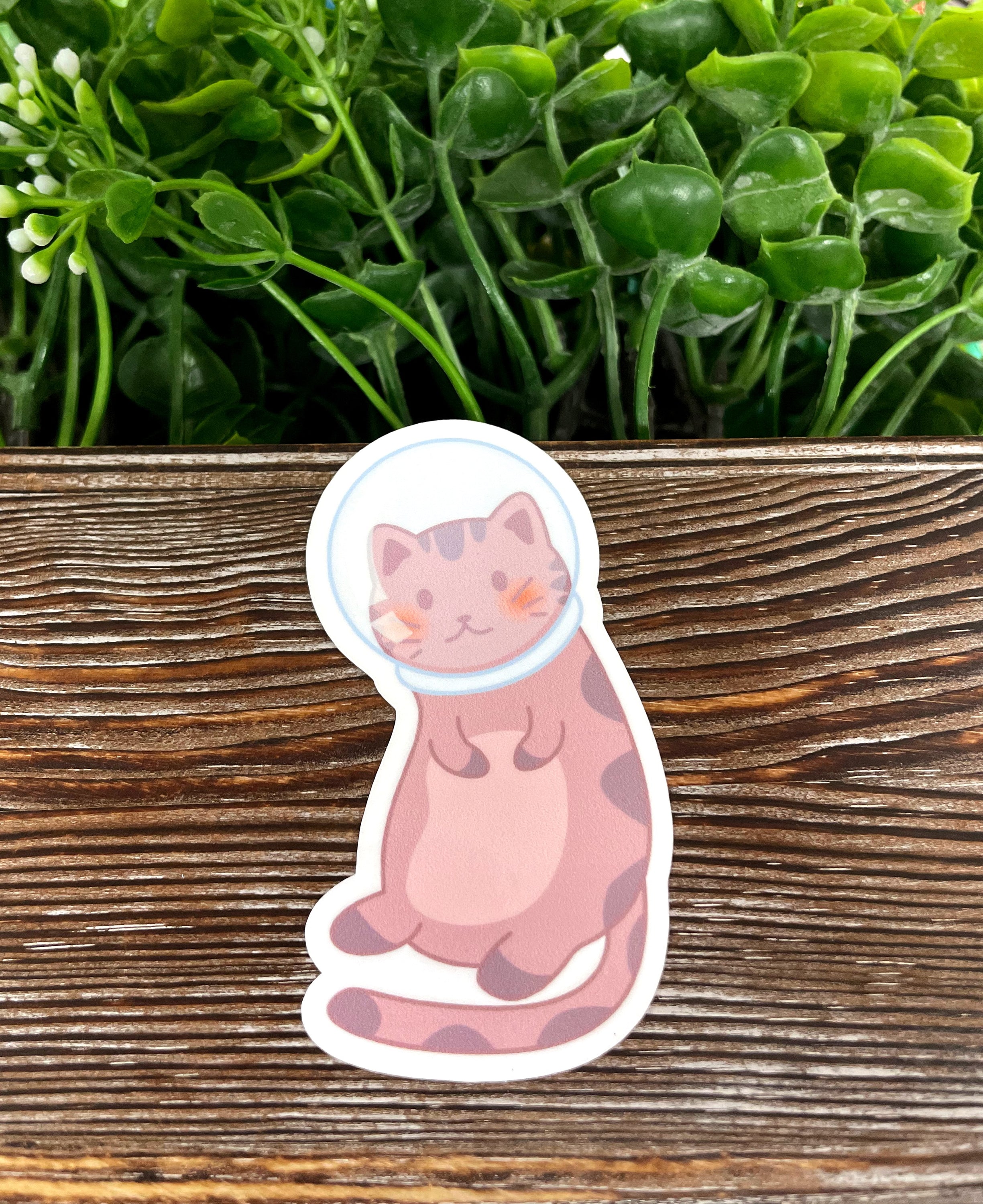 A vibrant Astronaut Cat Sticker featuring a playful cat in a space suit, perfect for decorating various surfaces.