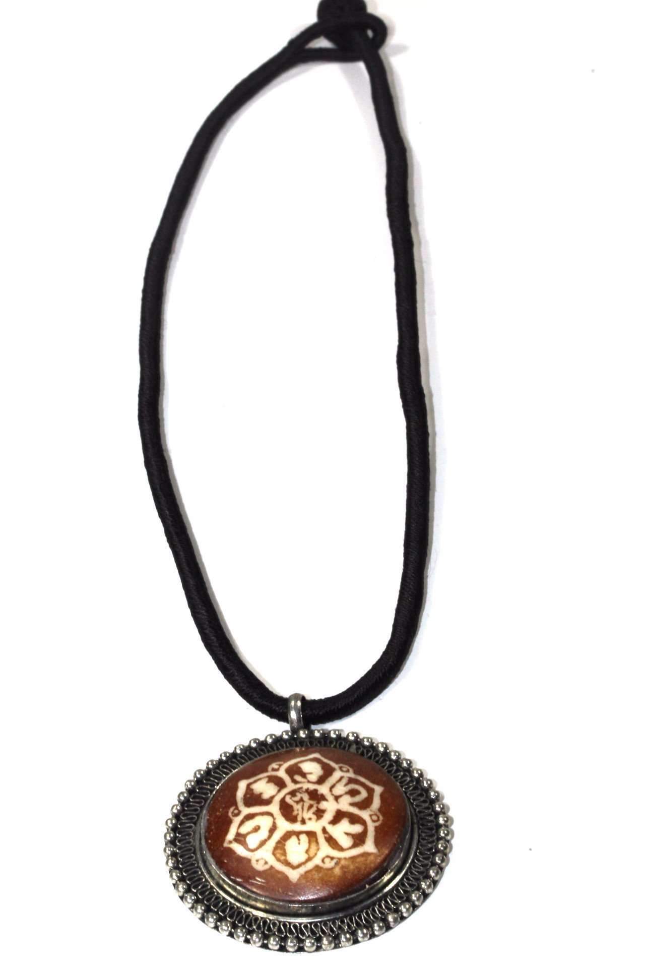 Auspicious Mandala Flower Spiritual Necklace featuring a bone pendant and black cotton chords, perfect for boho-chic style.