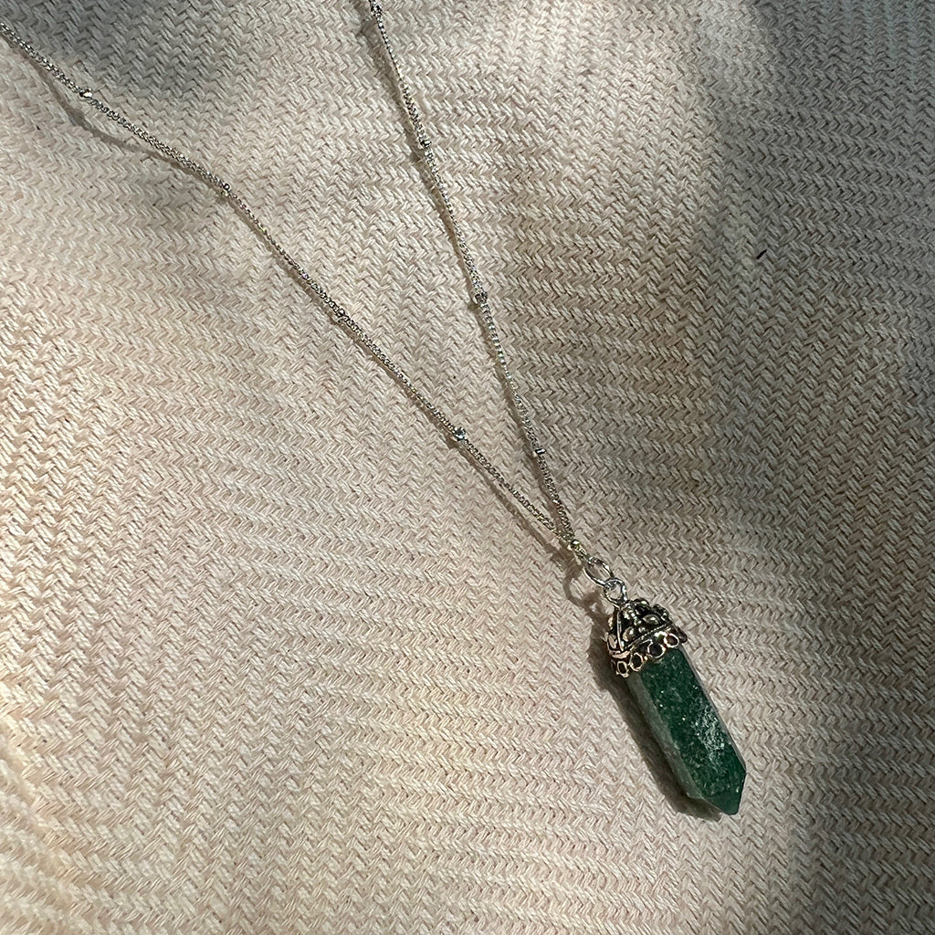 Aventurine crystal necklace with silver electroplated brass chain, showcasing its polished green stone and unique design.