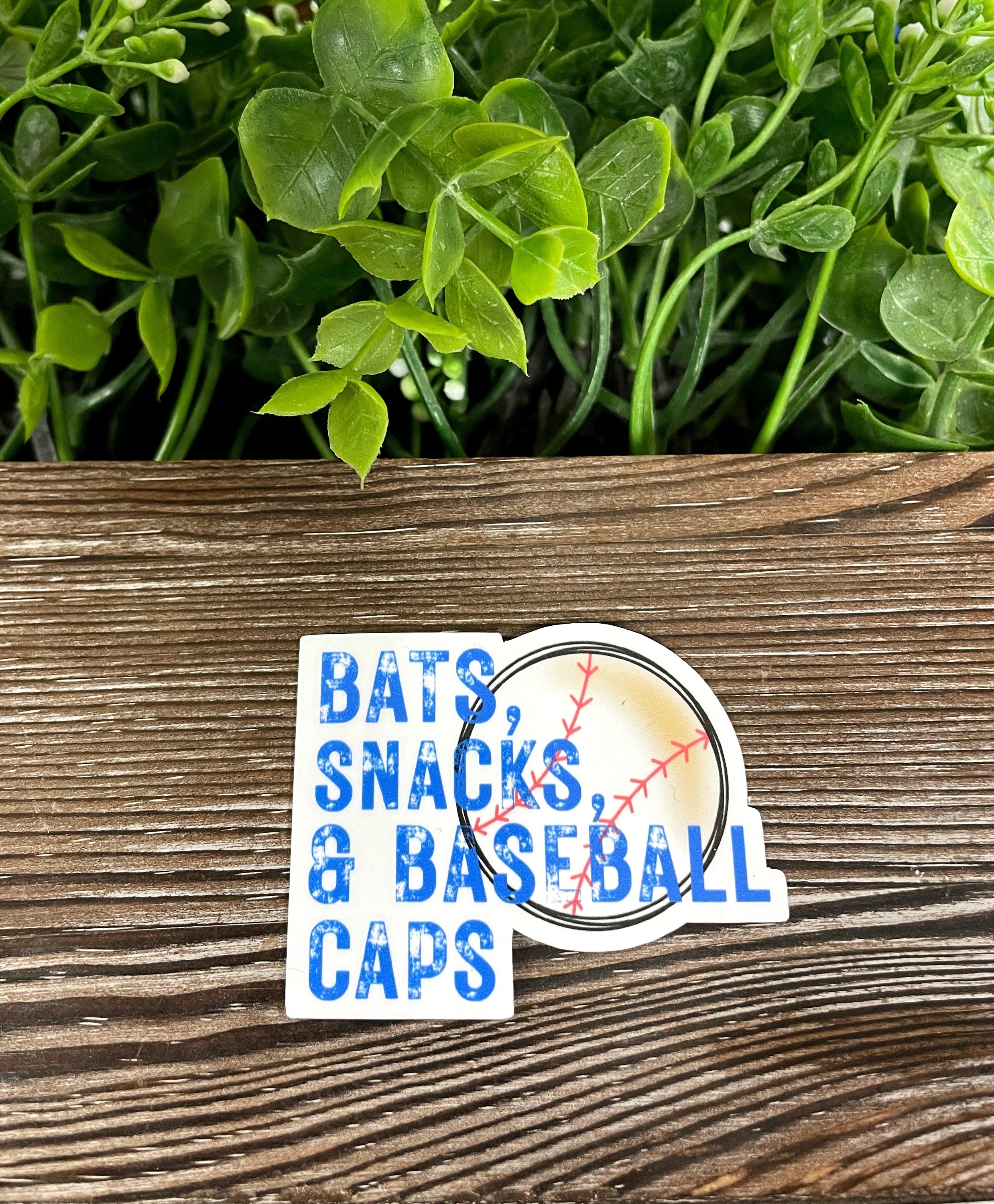 Bats Snack and Baseball Caps die cut vinyl sticker on a smooth surface, showcasing vibrant colors and fun design.