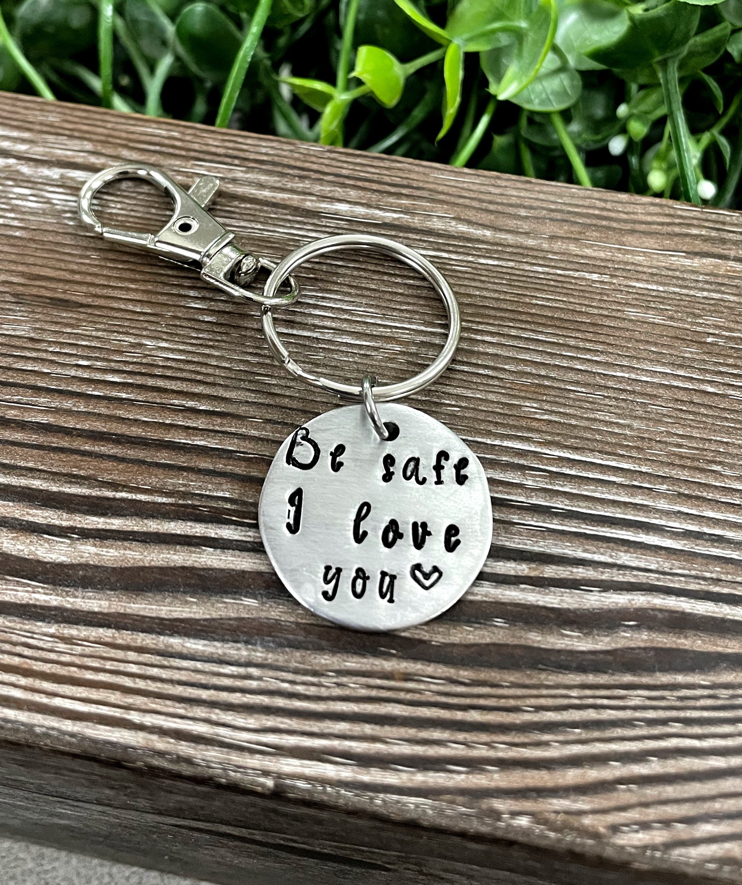 Hand Stamped Key Chain featuring the phrase 'Be Safe I Love You', showcasing unique lettering and craftsmanship.