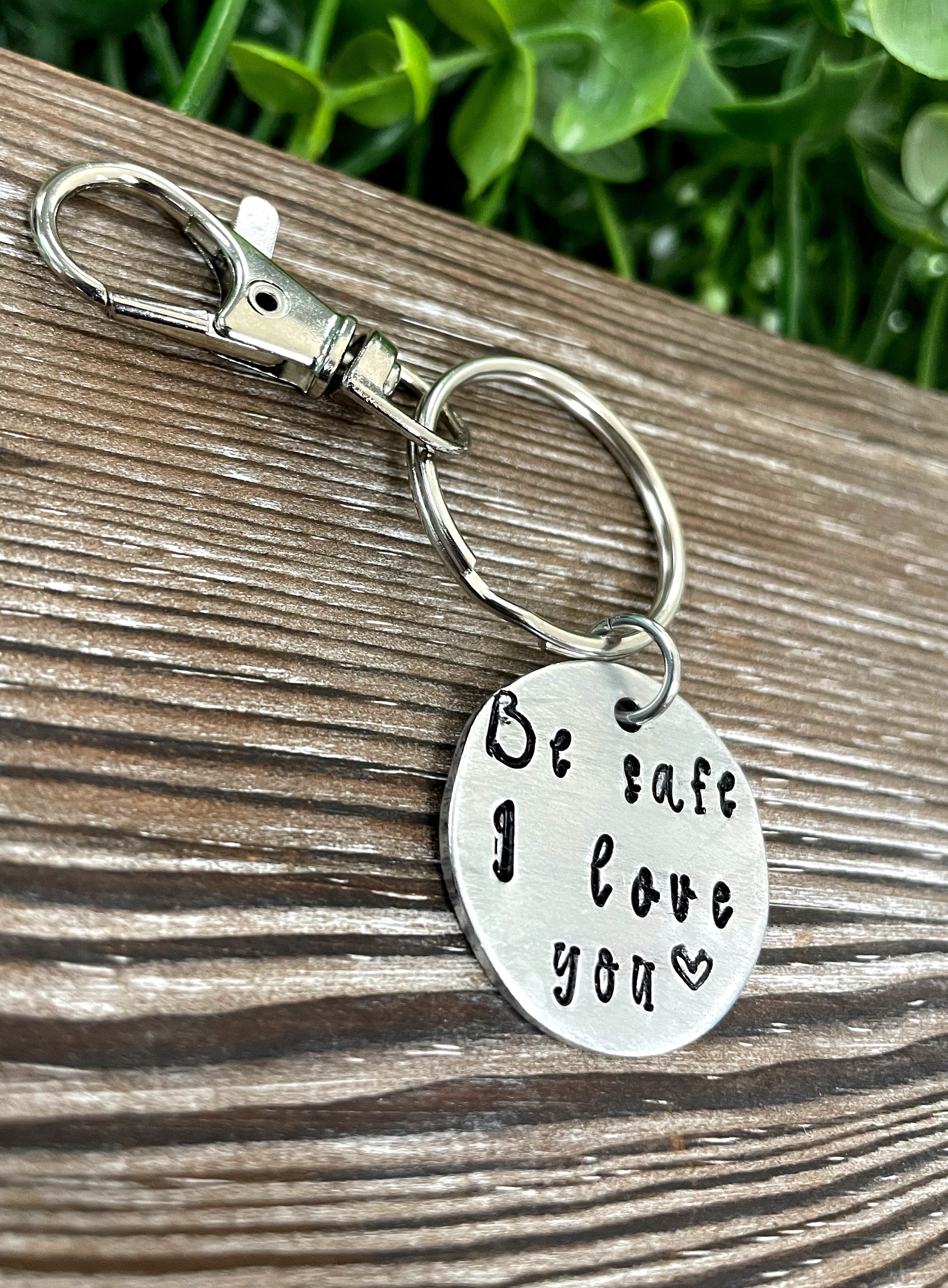 Hand Stamped Key Chain featuring the phrase 'Be Safe I Love You', showcasing unique lettering and craftsmanship.