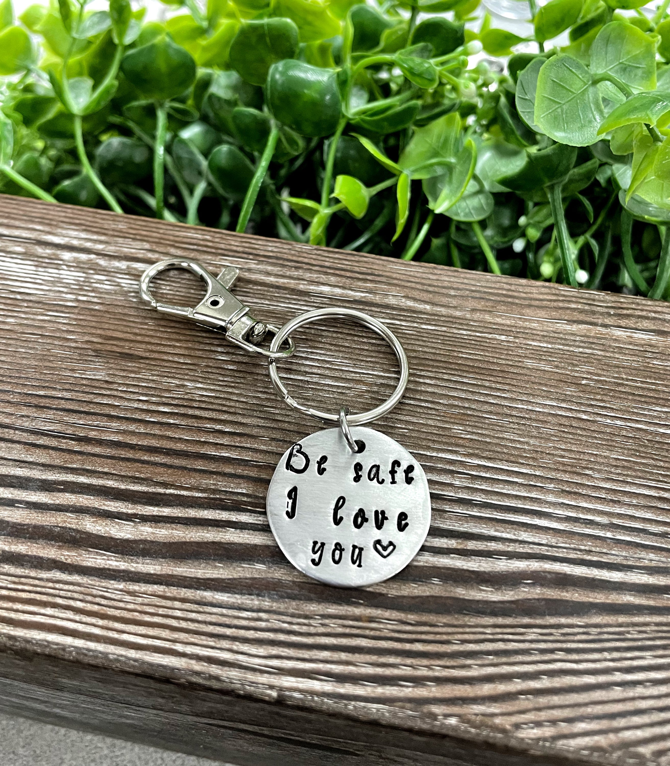 Hand Stamped Key Chain featuring the phrase 'Be Safe I Love You', showcasing unique lettering and craftsmanship.