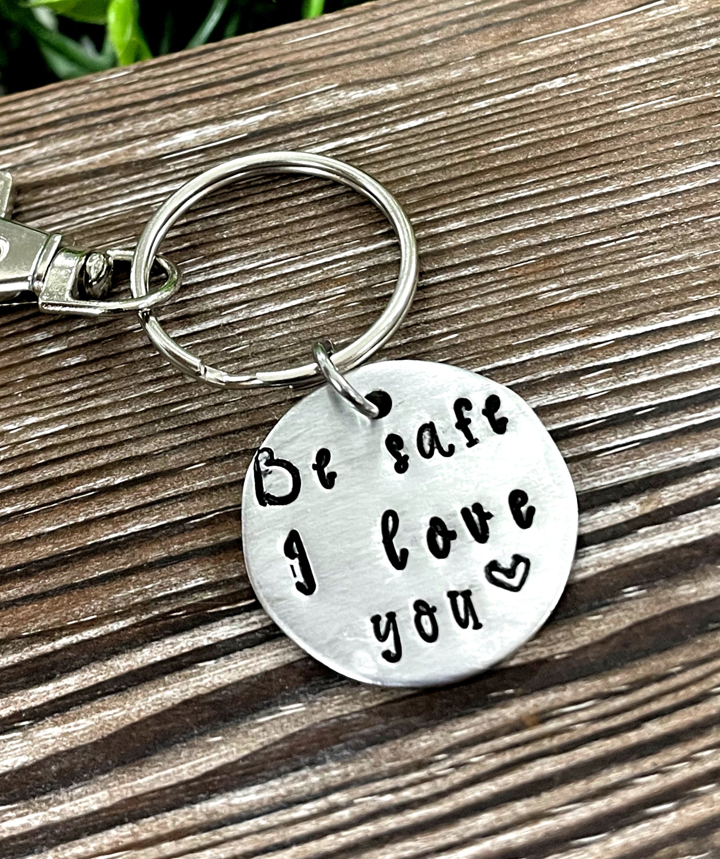 Hand Stamped Key Chain featuring the phrase 'Be Safe I Love You', showcasing unique lettering and craftsmanship.