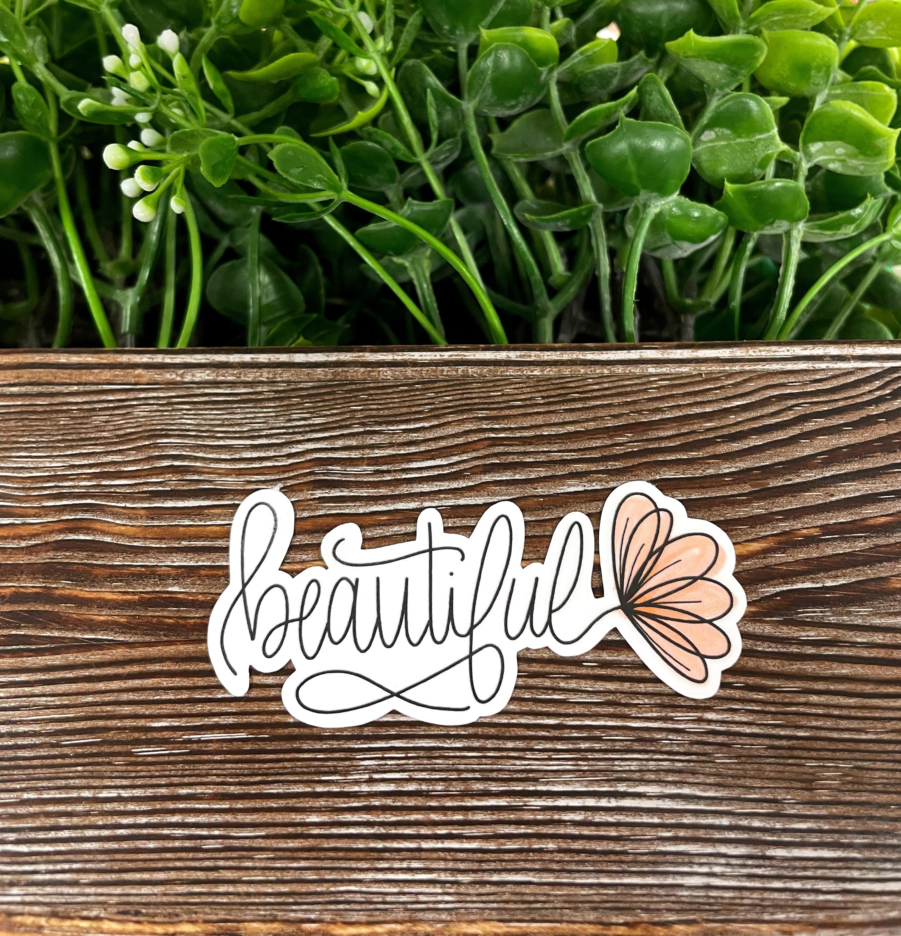 Beautiful Script Lettering die cut sticker on a smooth surface, showcasing vibrant colors and intricate design.