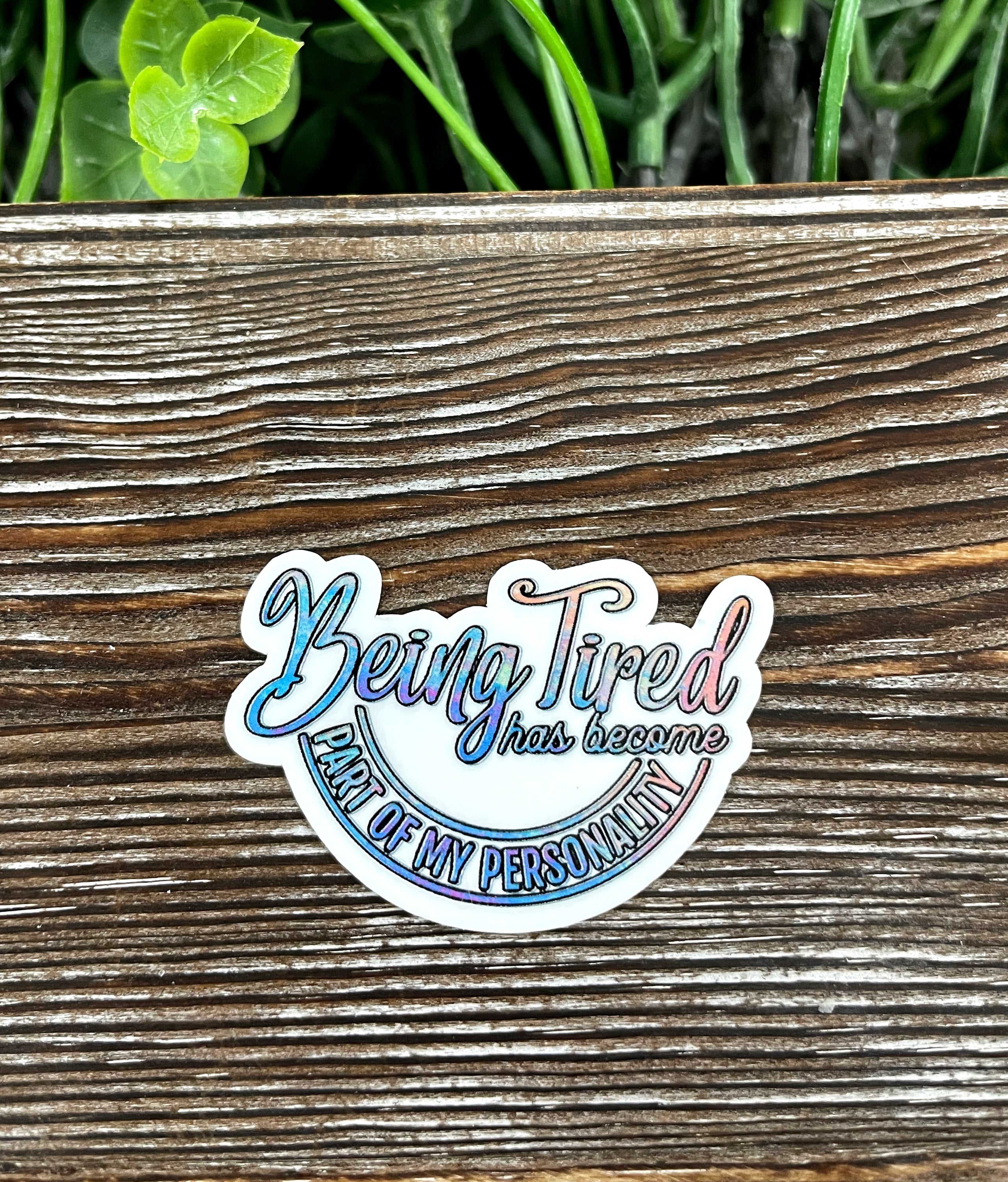 A die cut vinyl sticker with the quote 'Being Tired has Become Part of my Personality' in a stylish font, showcasing its vibrant colors and quality finish.