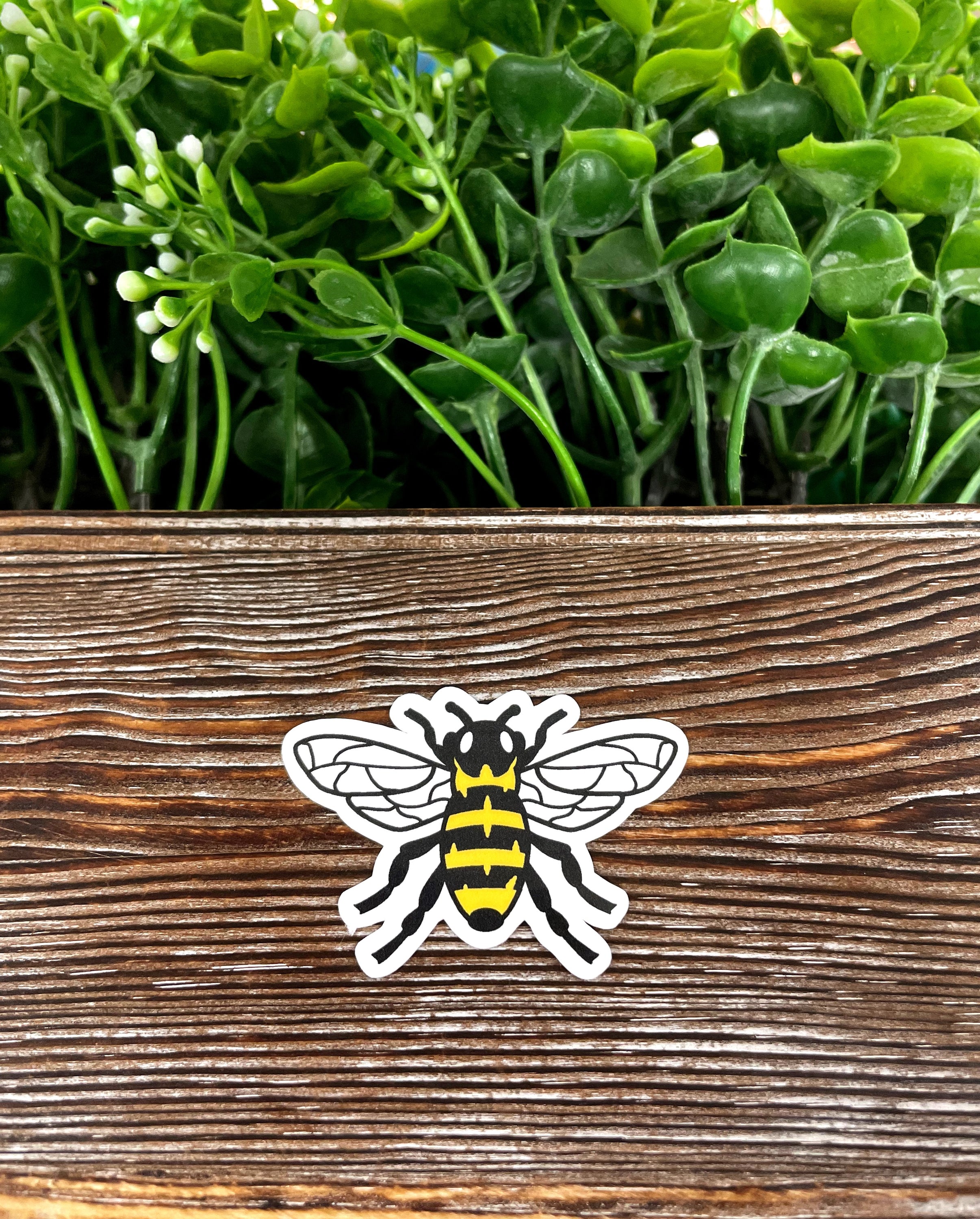 Black and yellow die cut vinyl sticker featuring a bee design, perfect for personalizing various items.