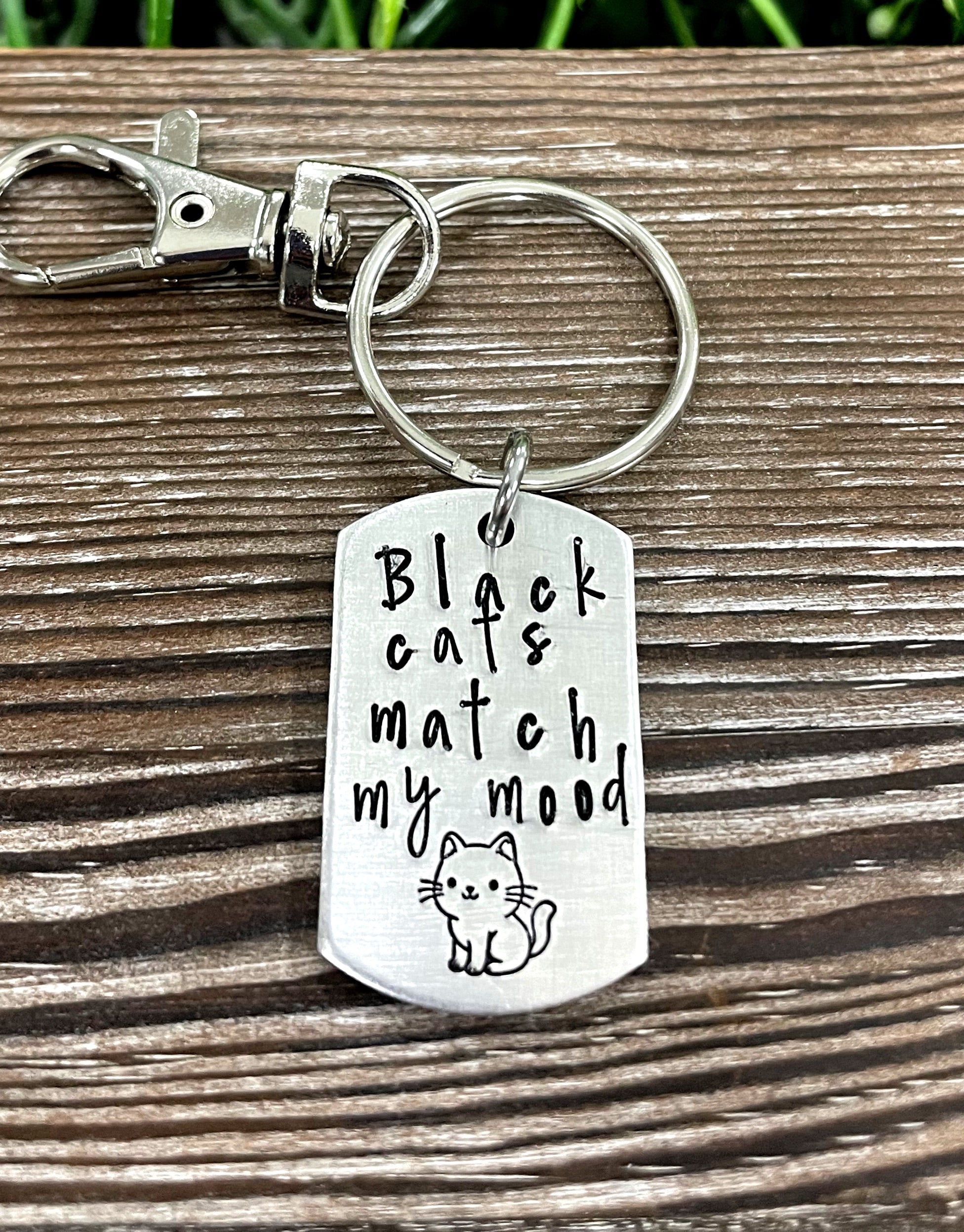 Hand-stamped key chain featuring the phrase 'Black cats Match my mood' with a fun animal theme, showcasing unique craftsmanship.