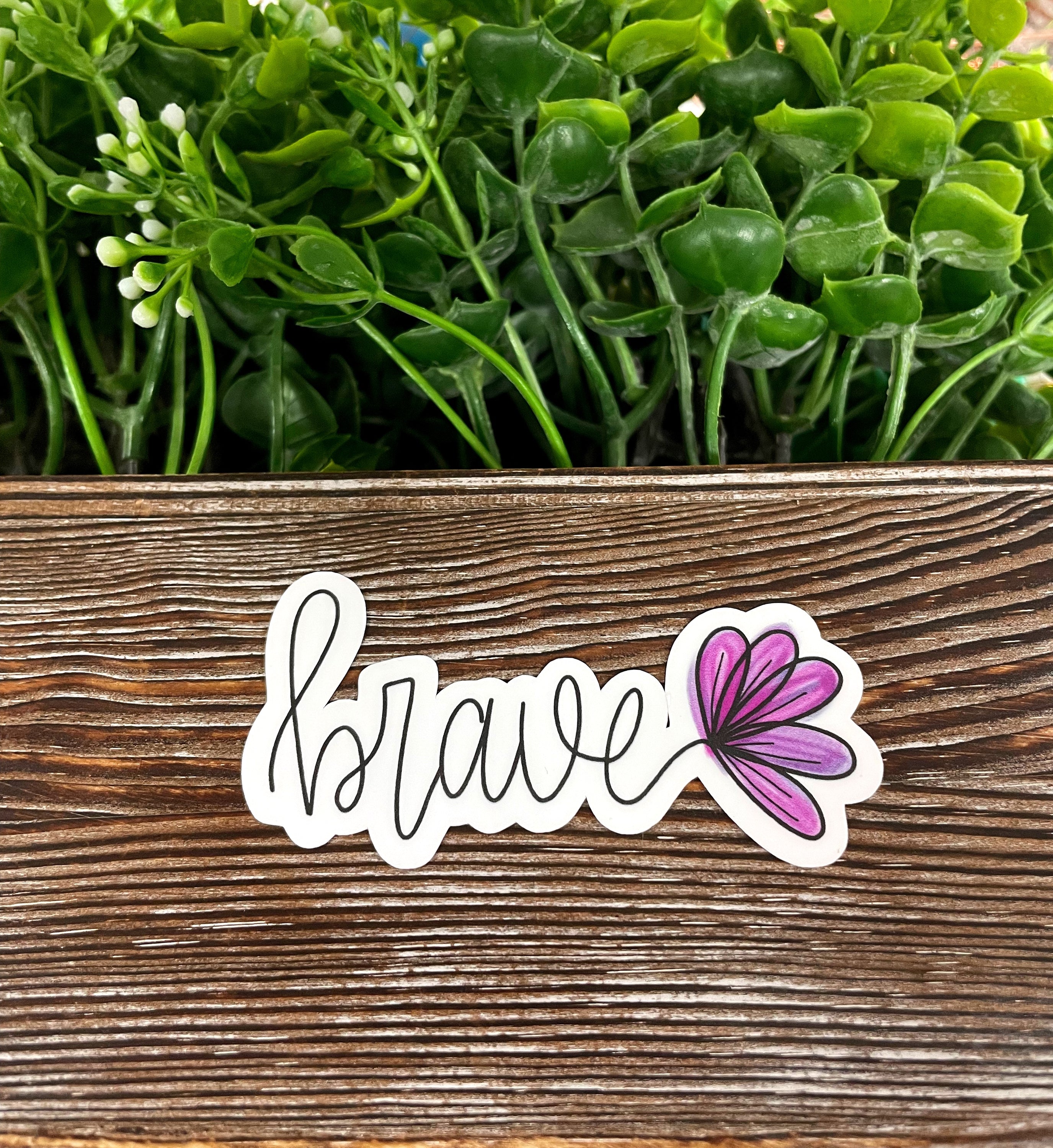 Brave Script Lettering Sticker on a smooth surface, showcasing vibrant colors and stylish design.