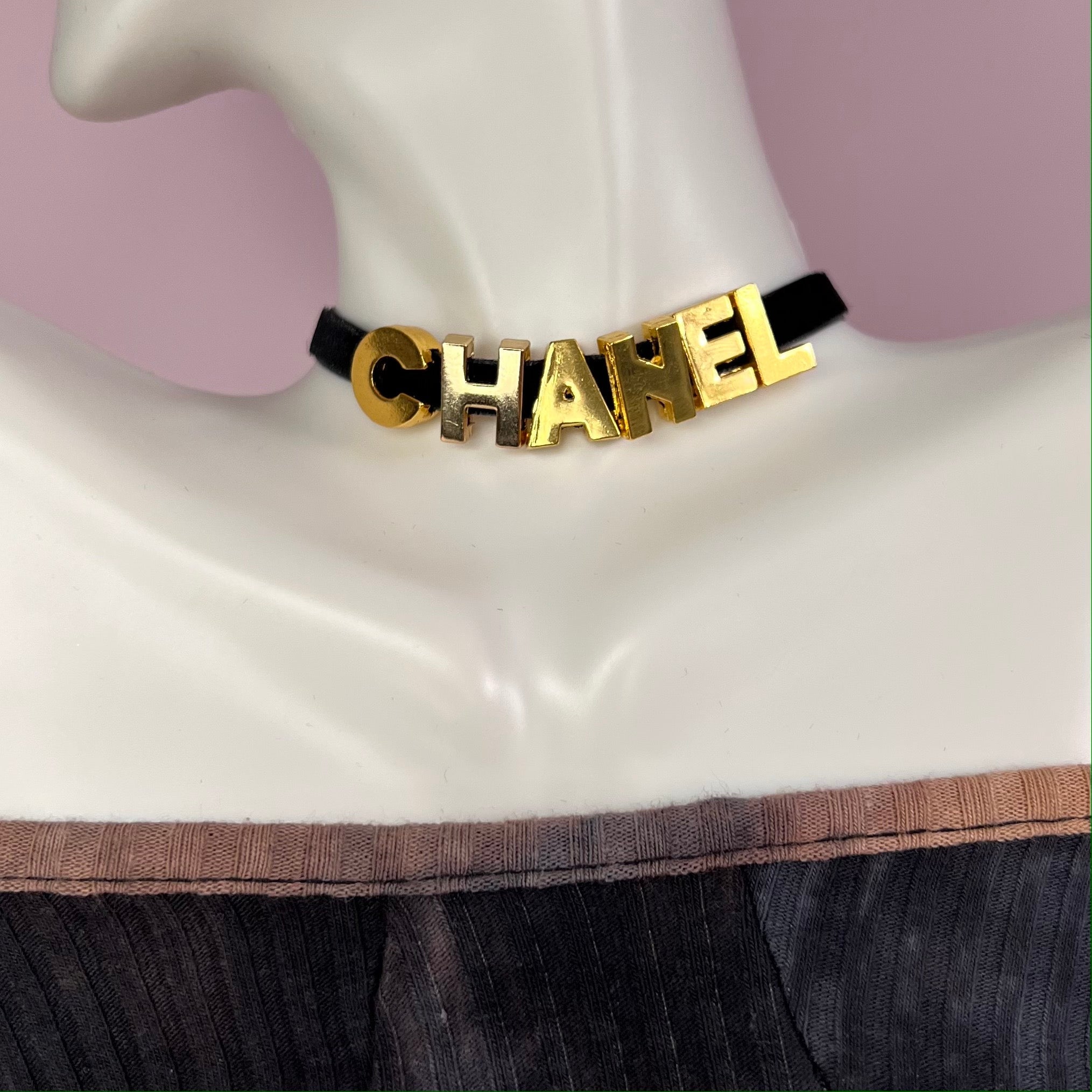 A stylish 'C' Choker Necklace featuring non-tarnish stainless steel letters on a soft velvet cord, available in gold and silver.