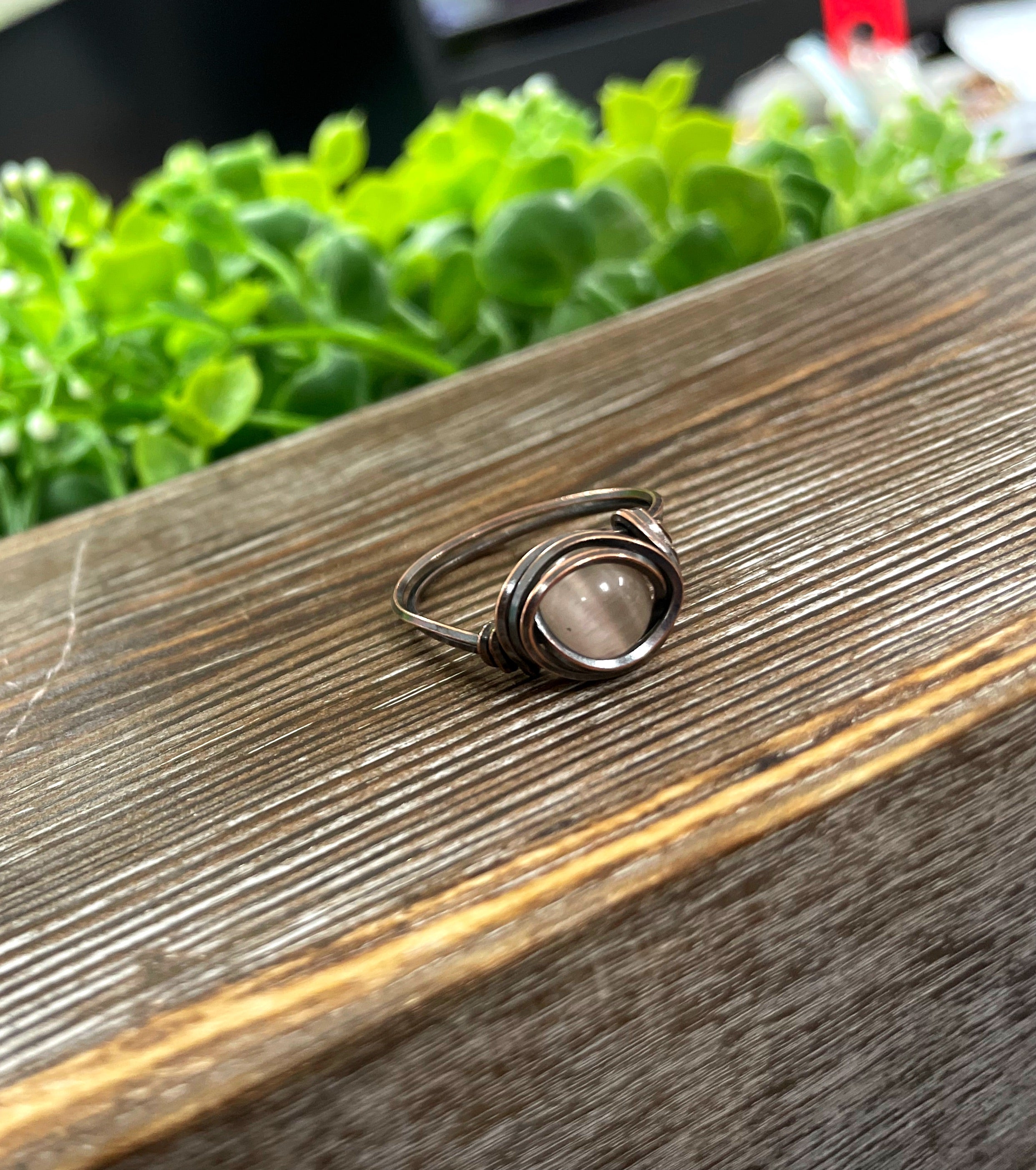 Cat Eye Glass Crystal Wire Wrapped Ring featuring red and black glass beads wrapped in oxidized copper wire, showcasing an antique look.