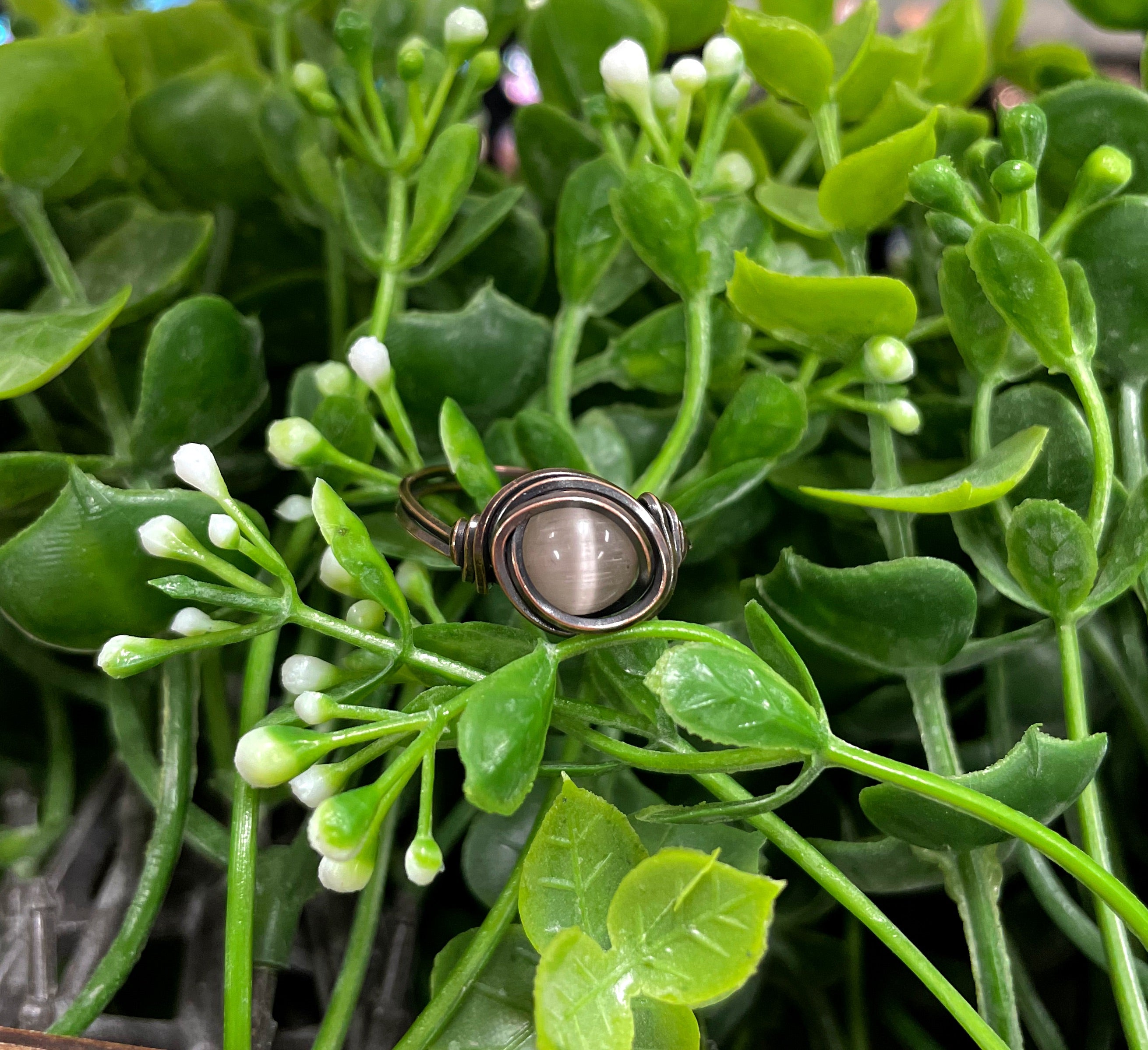 Cat Eye Glass Crystal Wire Wrapped Ring featuring red and black glass beads wrapped in oxidized copper wire, showcasing an antique look.