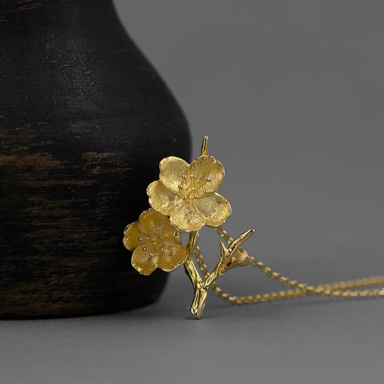 A beautiful Cherry Blossoms Necklace featuring three intricately designed cherry blossom flowers in 925 sterling silver with 18k gold plating.