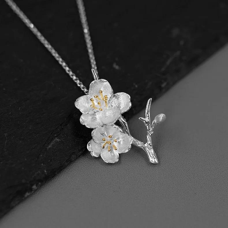 A beautiful Cherry Blossoms Necklace featuring three intricately designed cherry blossom flowers in 925 sterling silver with 18k gold plating.