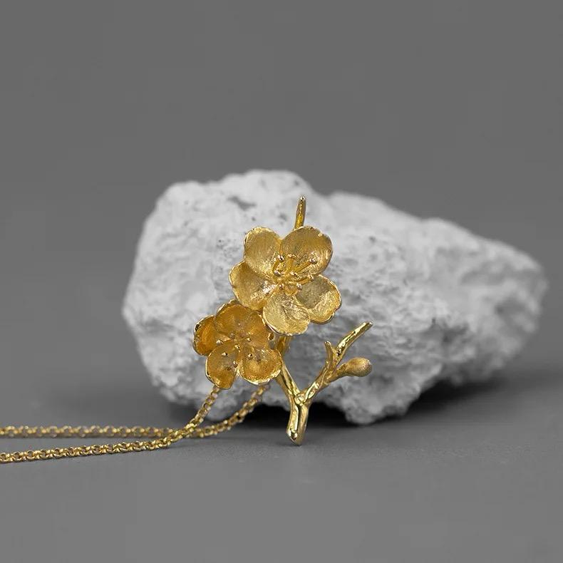 A beautiful Cherry Blossoms Necklace featuring three intricately designed cherry blossom flowers in 925 sterling silver with 18k gold plating.