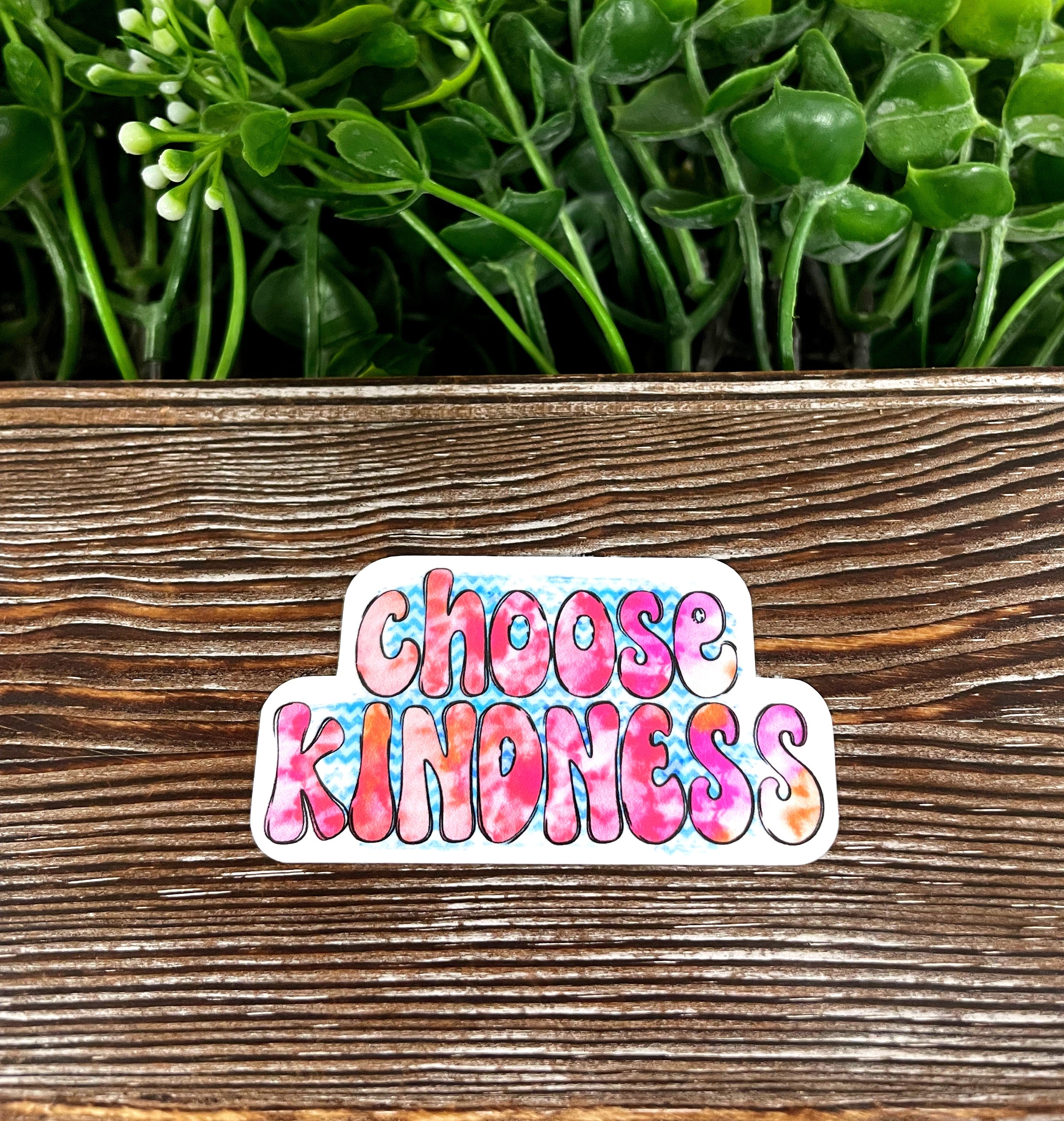 Choose Kindness Groovy die cut sticker on a smooth surface, showcasing vibrant colors and a fun design.