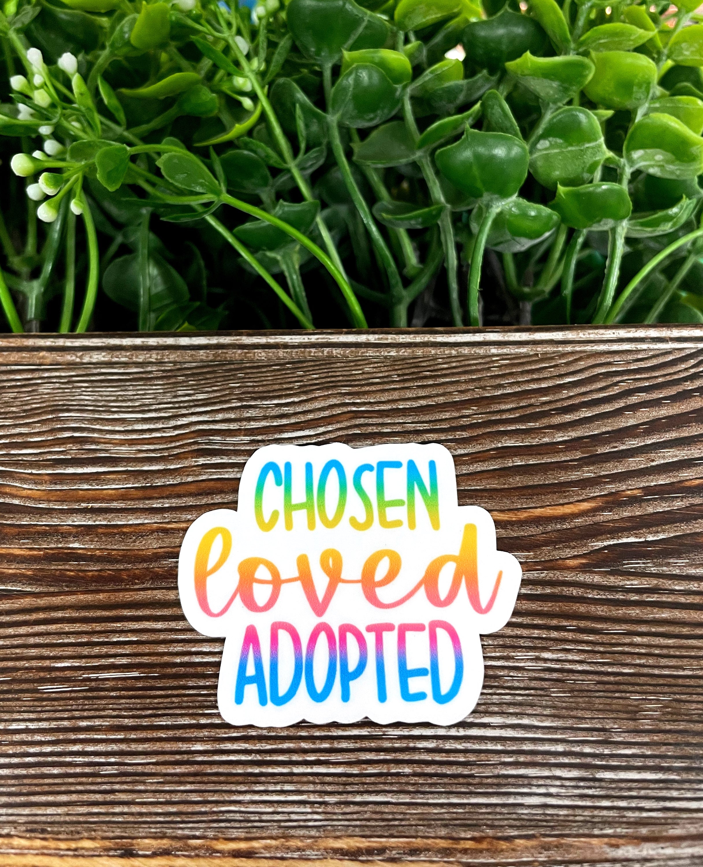 Chosen Loved Adopted die cut sticker on a smooth surface, showcasing vibrant colors and a unique design.