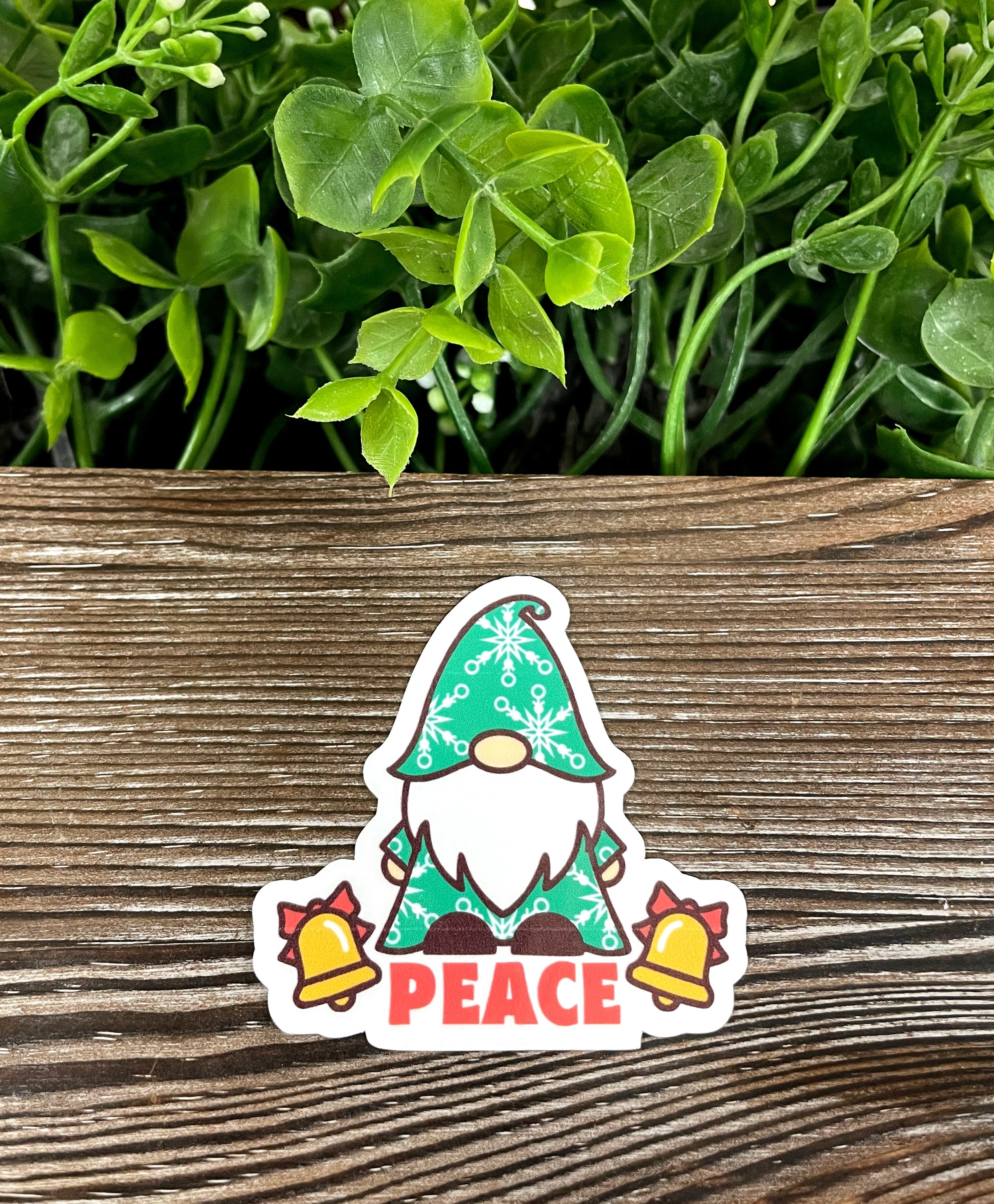 A colorful die cut vinyl sticker featuring a Christmas bearded gnome with a peace theme, perfect for personalizing items.