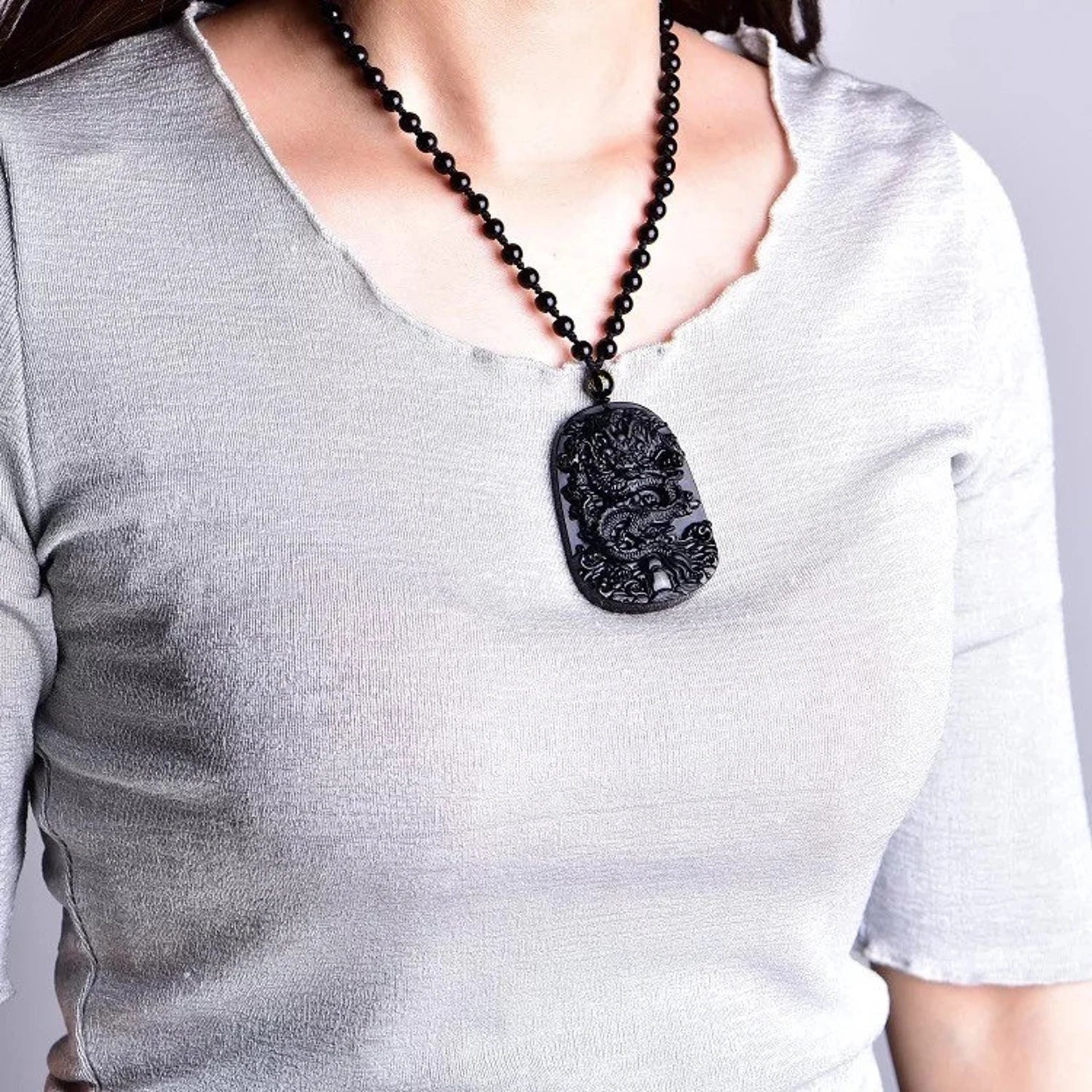 Collier Dragon en Obsidienne Noire avec pendentif dragon, perles noires et cordon ajustable, symbole de protection et de chance.