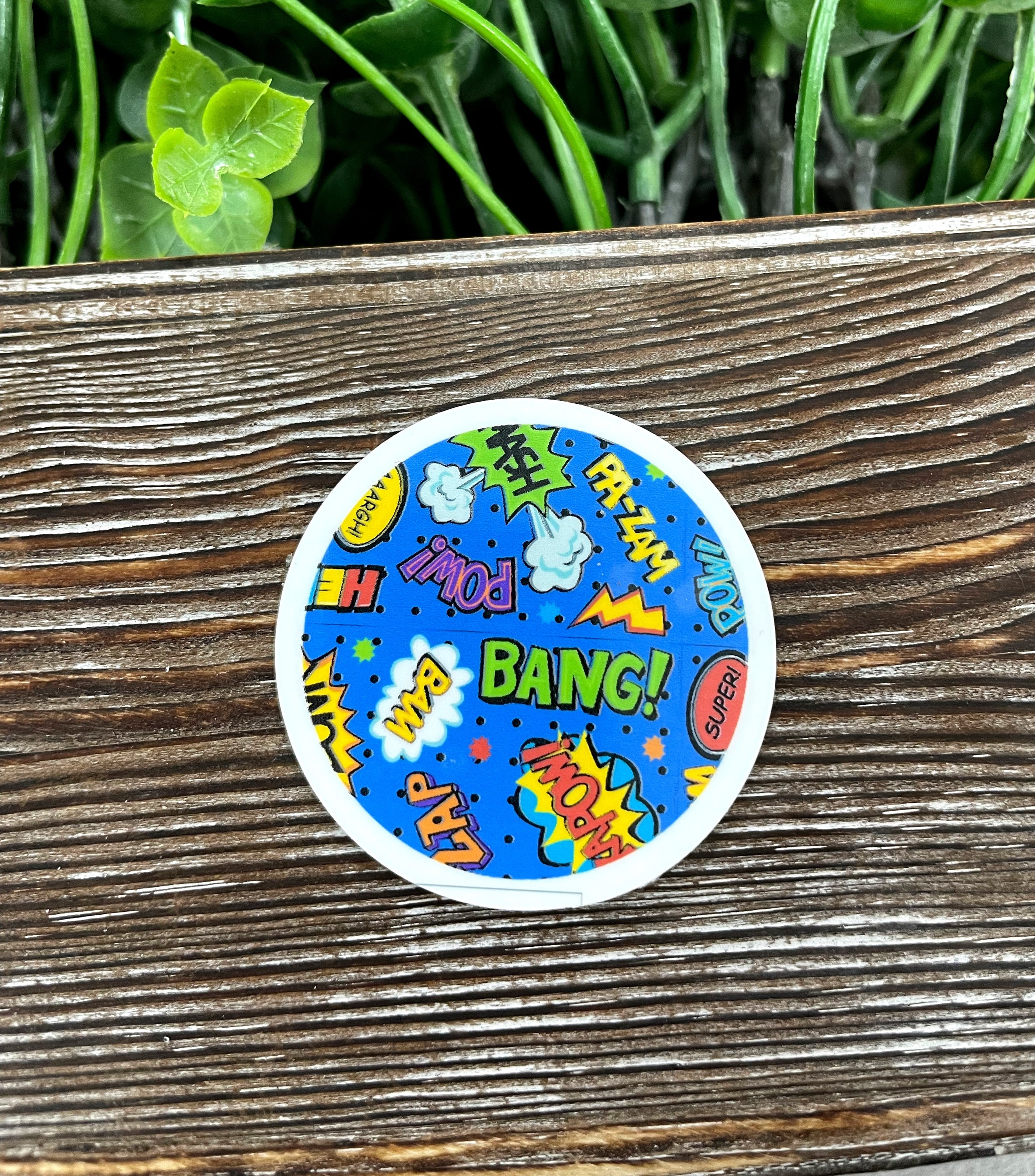 A vibrant comic book style die cut sticker featuring colorful graphic art, perfect for personalizing various surfaces.