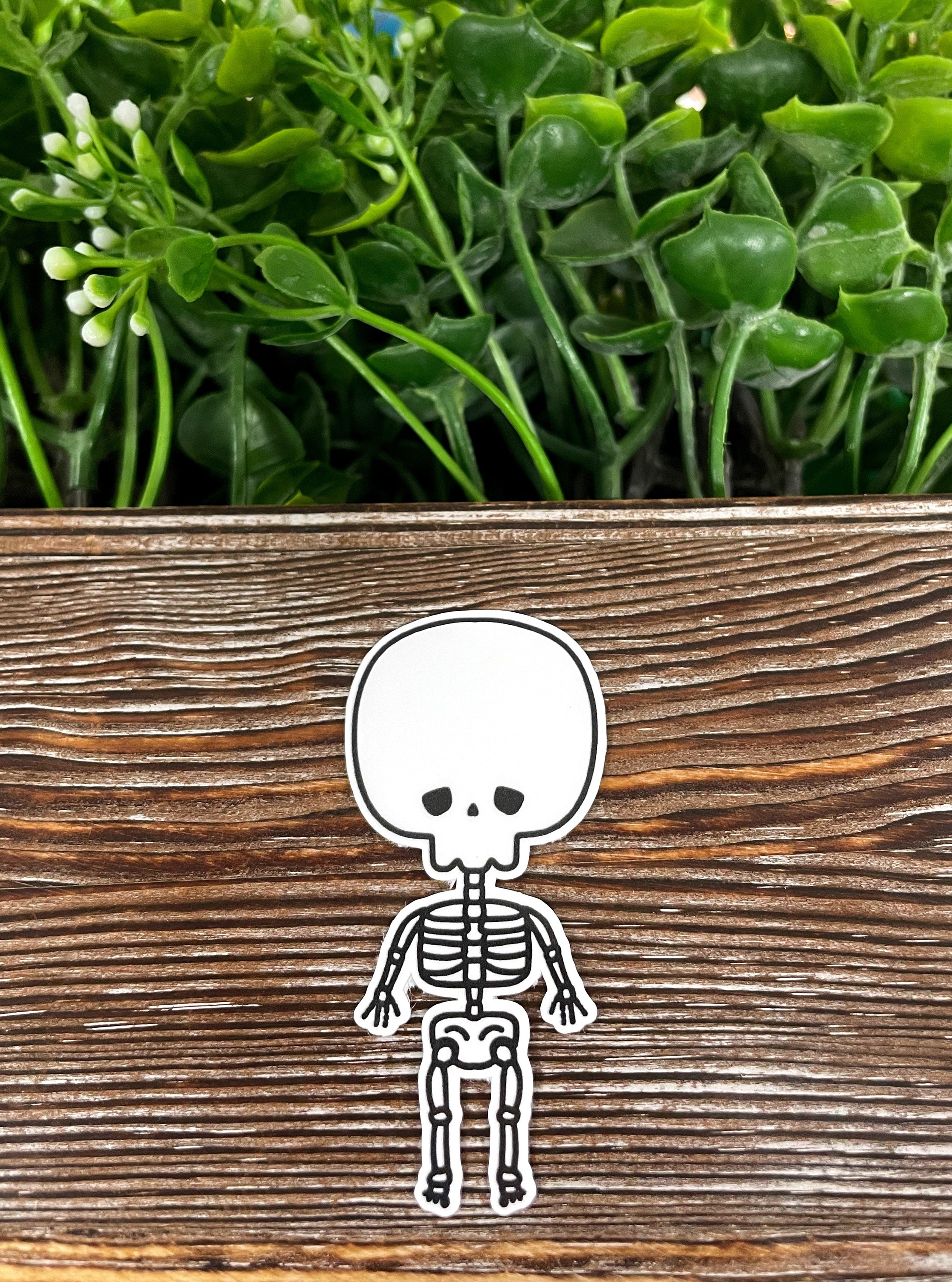 Cute Skeleton die cut sticker on a smooth surface, showcasing vibrant colors and intricate design.