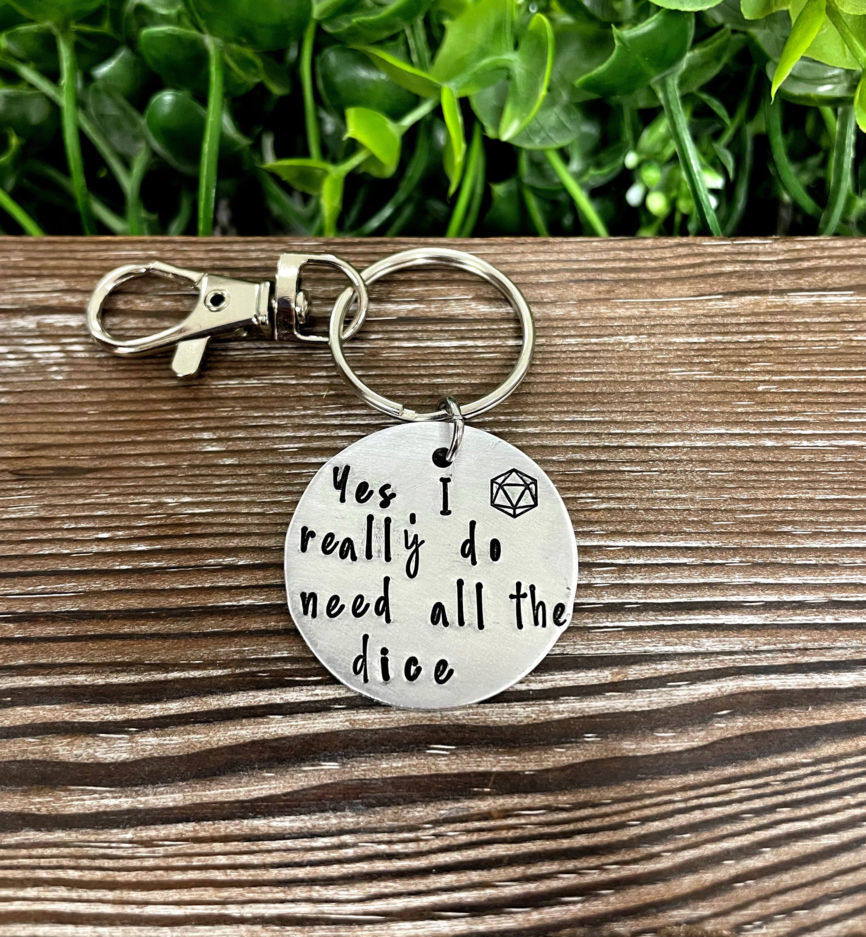 Hand-stamped key chain featuring a dice-themed design with the phrase 'Yes I really do need all the dice', showcasing unique craftsmanship.