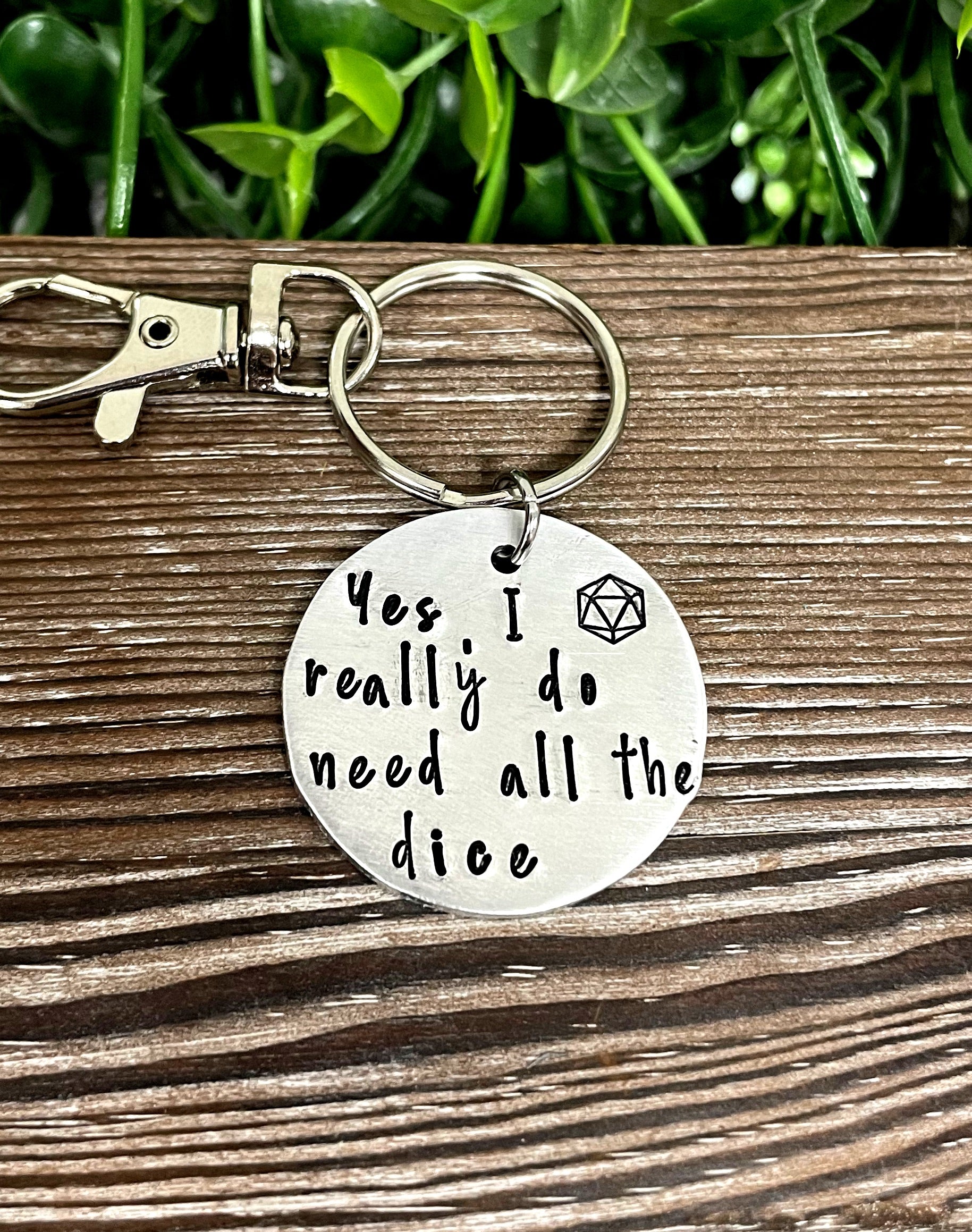 Hand-stamped key chain featuring a dice-themed design with the phrase 'Yes I really do need all the dice', showcasing unique craftsmanship.