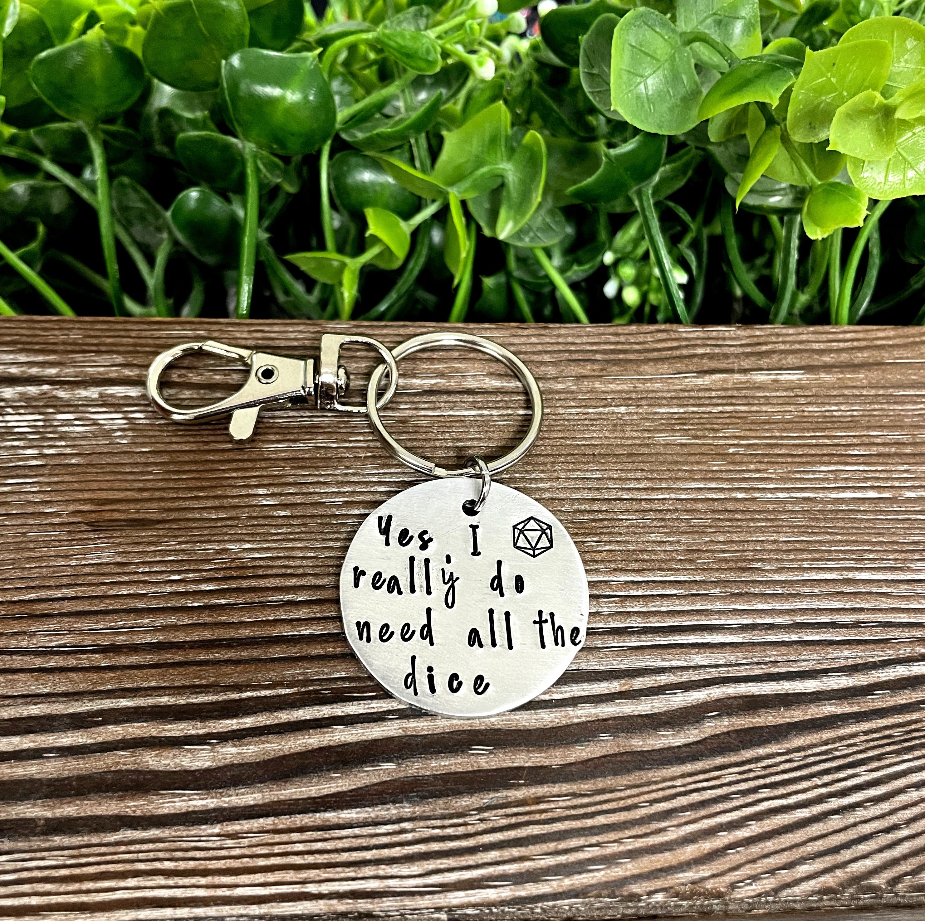 Hand-stamped key chain featuring a dice-themed design with the phrase 'Yes I really do need all the dice', showcasing unique craftsmanship.