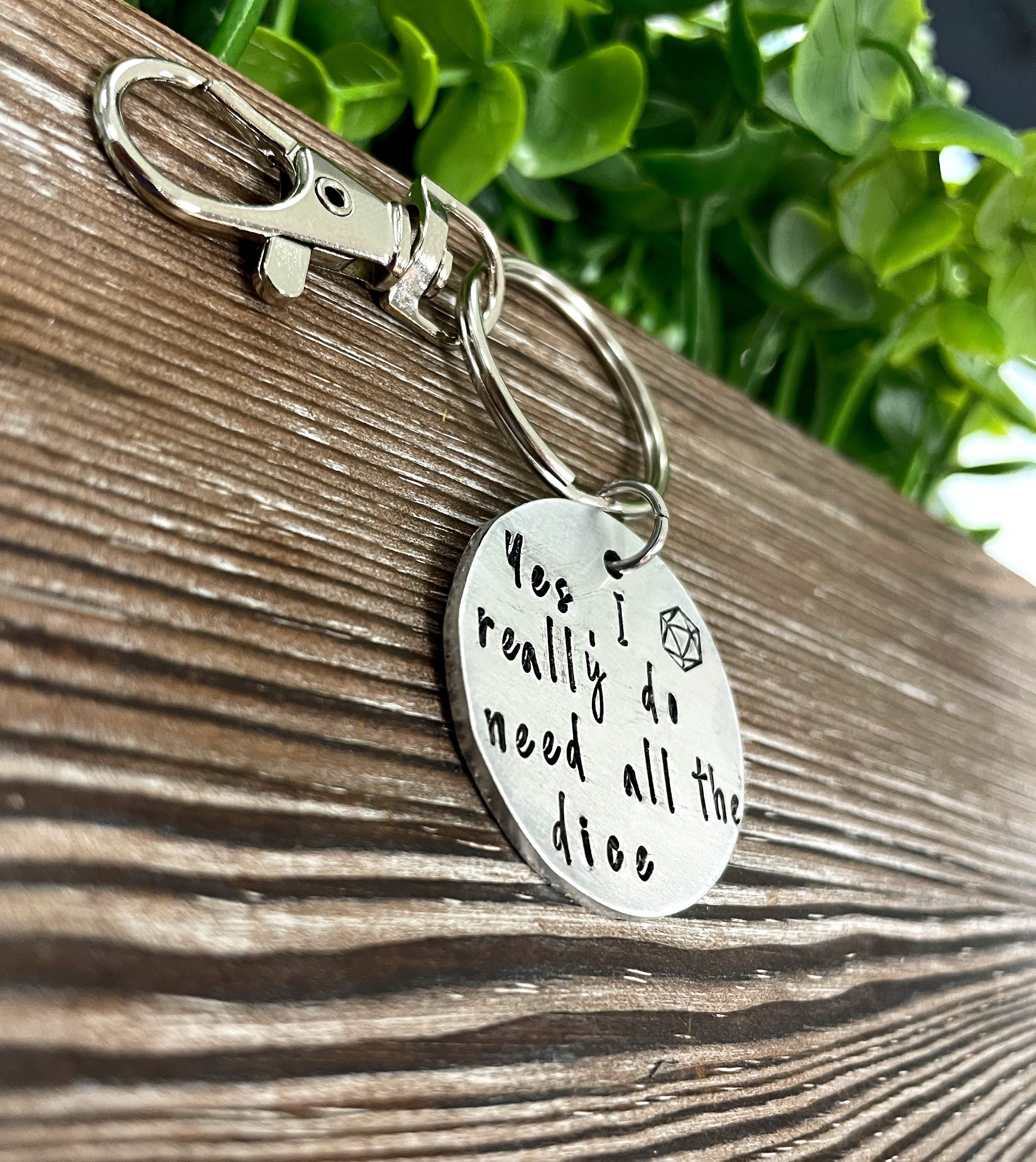 Hand-stamped key chain featuring a dice-themed design with the phrase 'Yes I really do need all the dice', showcasing unique craftsmanship.