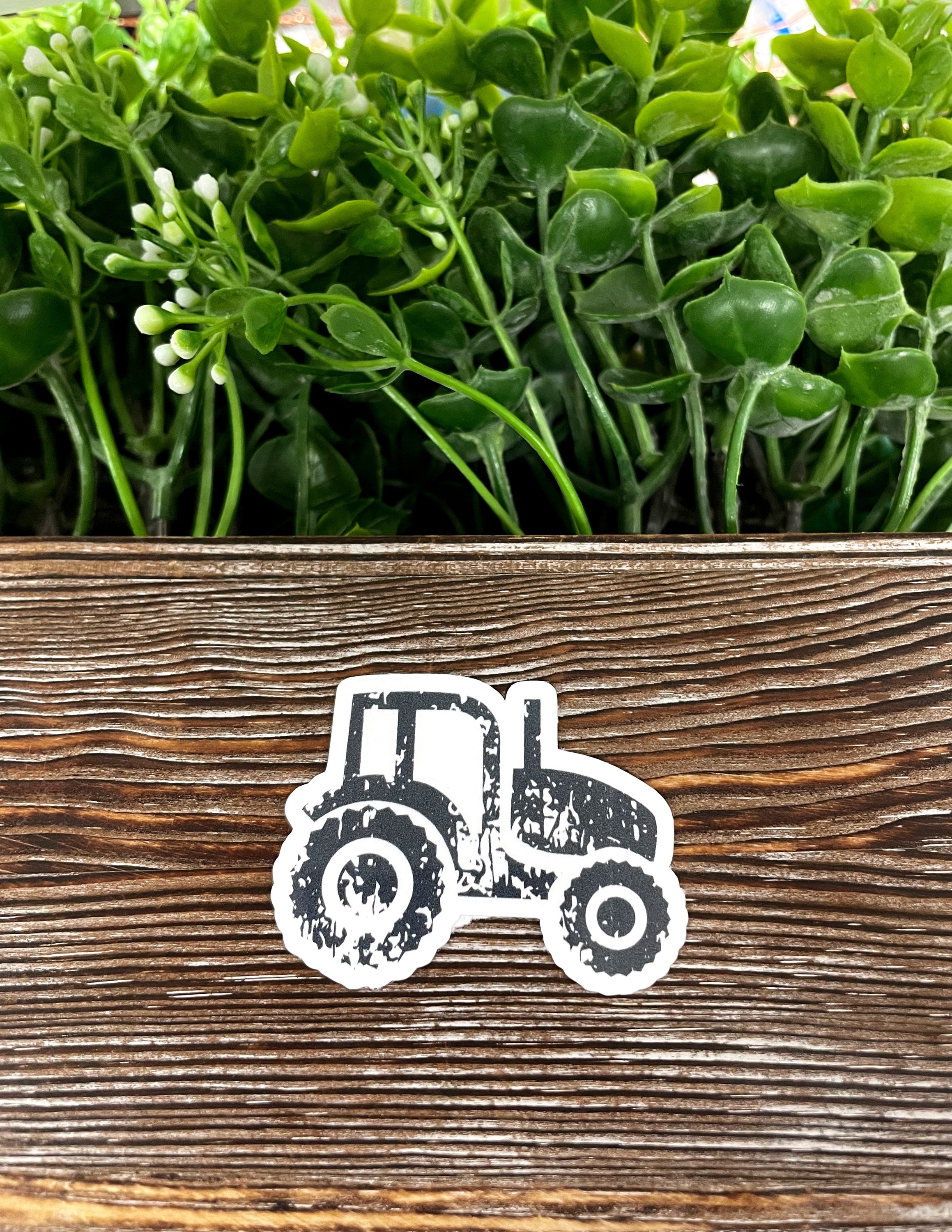 Distressed Farm Tractor die cut vinyl sticker on a smooth surface, showcasing vibrant colors and intricate design.