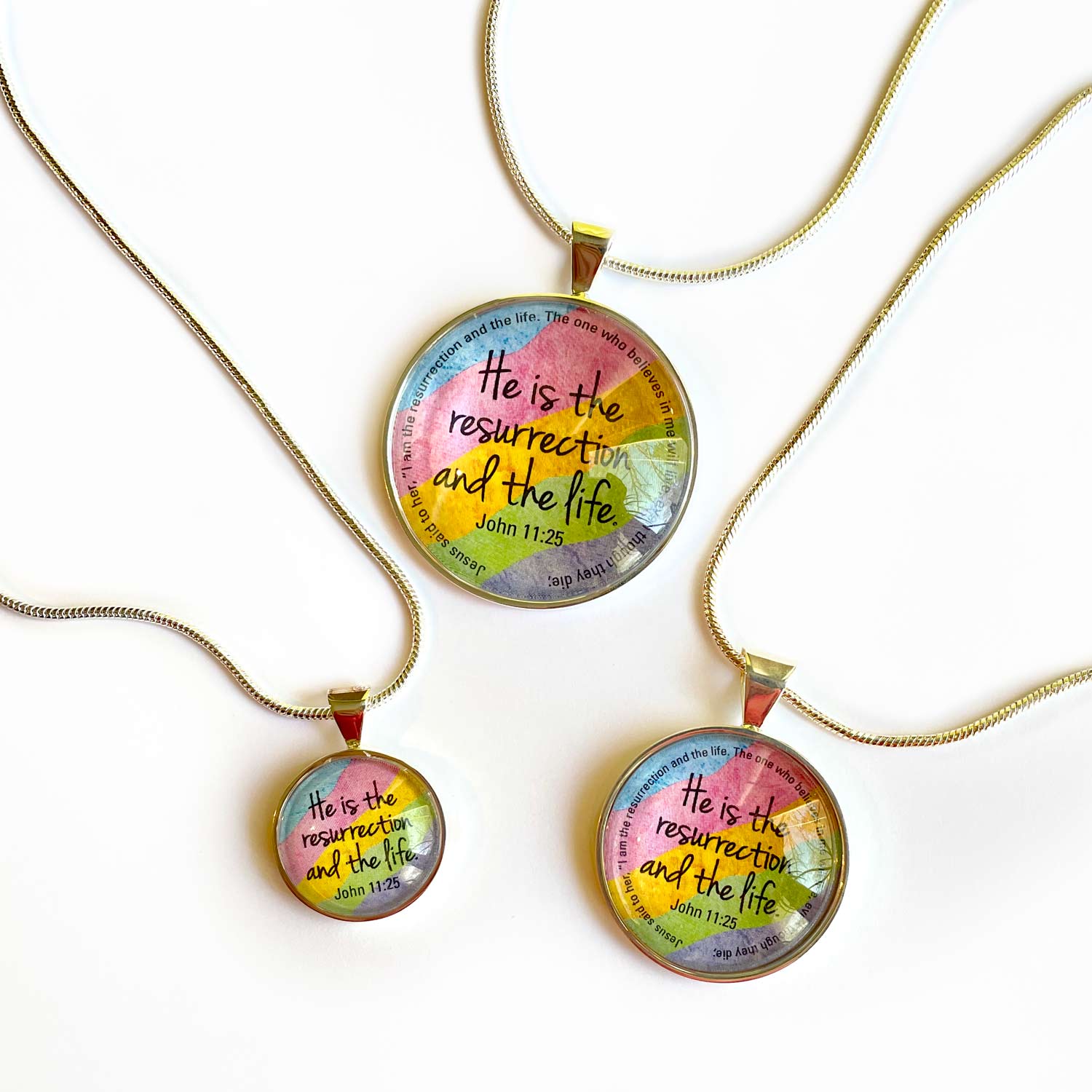 Easter Scripture Silver-Plated Colorful Christian Pendant Necklace featuring vibrant spring colors and a scripture verse from John 11:25.