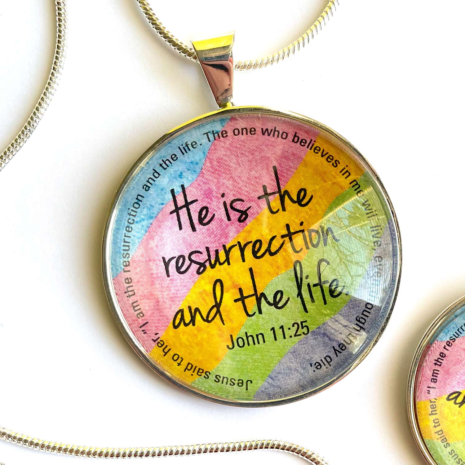 Easter Scripture Silver-Plated Colorful Christian Pendant Necklace featuring vibrant spring colors and a scripture verse from John 11:25.