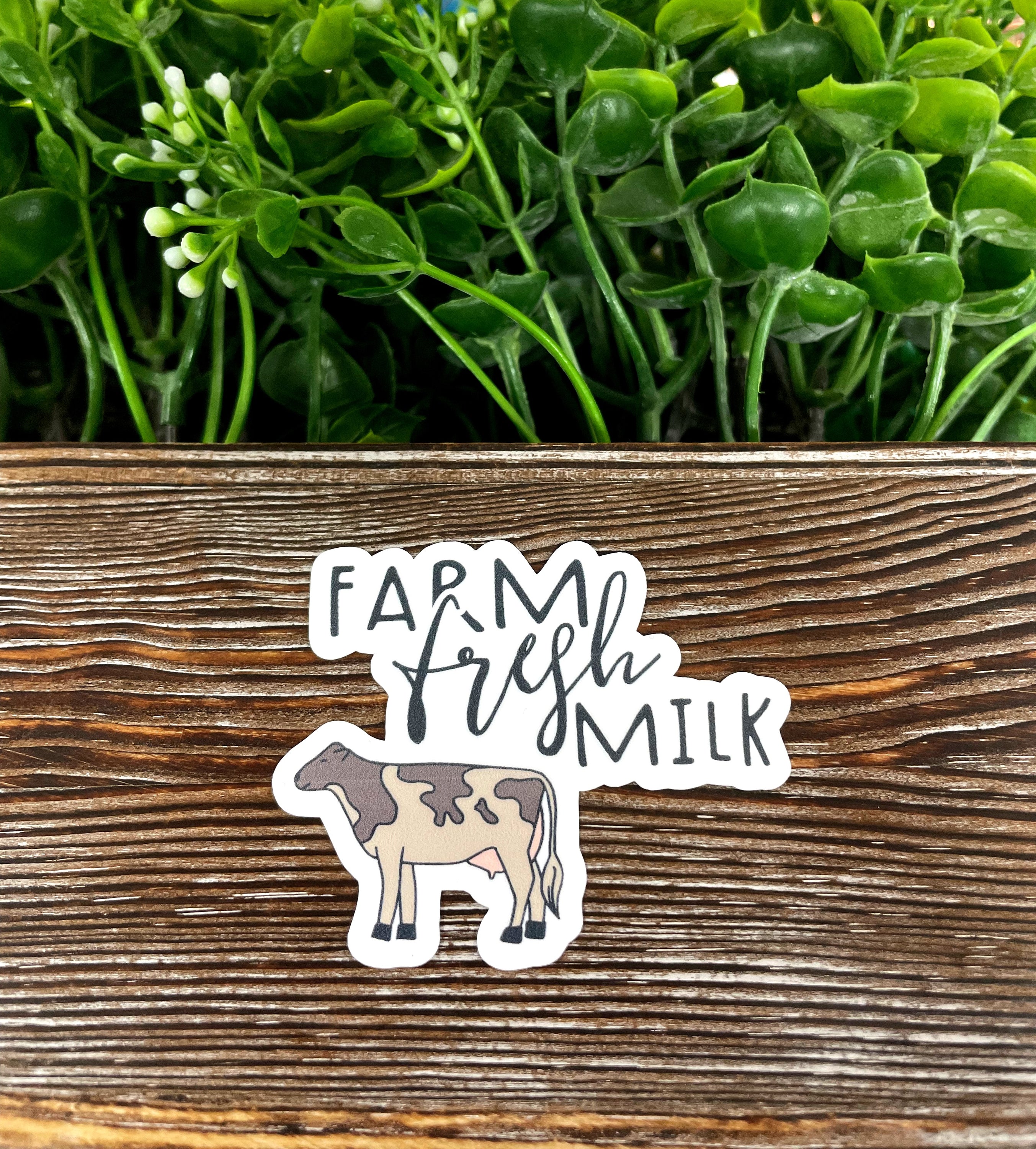 A colorful die cut vinyl sticker featuring a whimsical Farm Fresh Milk Cow design, perfect for personalizing water bottles and notebooks.