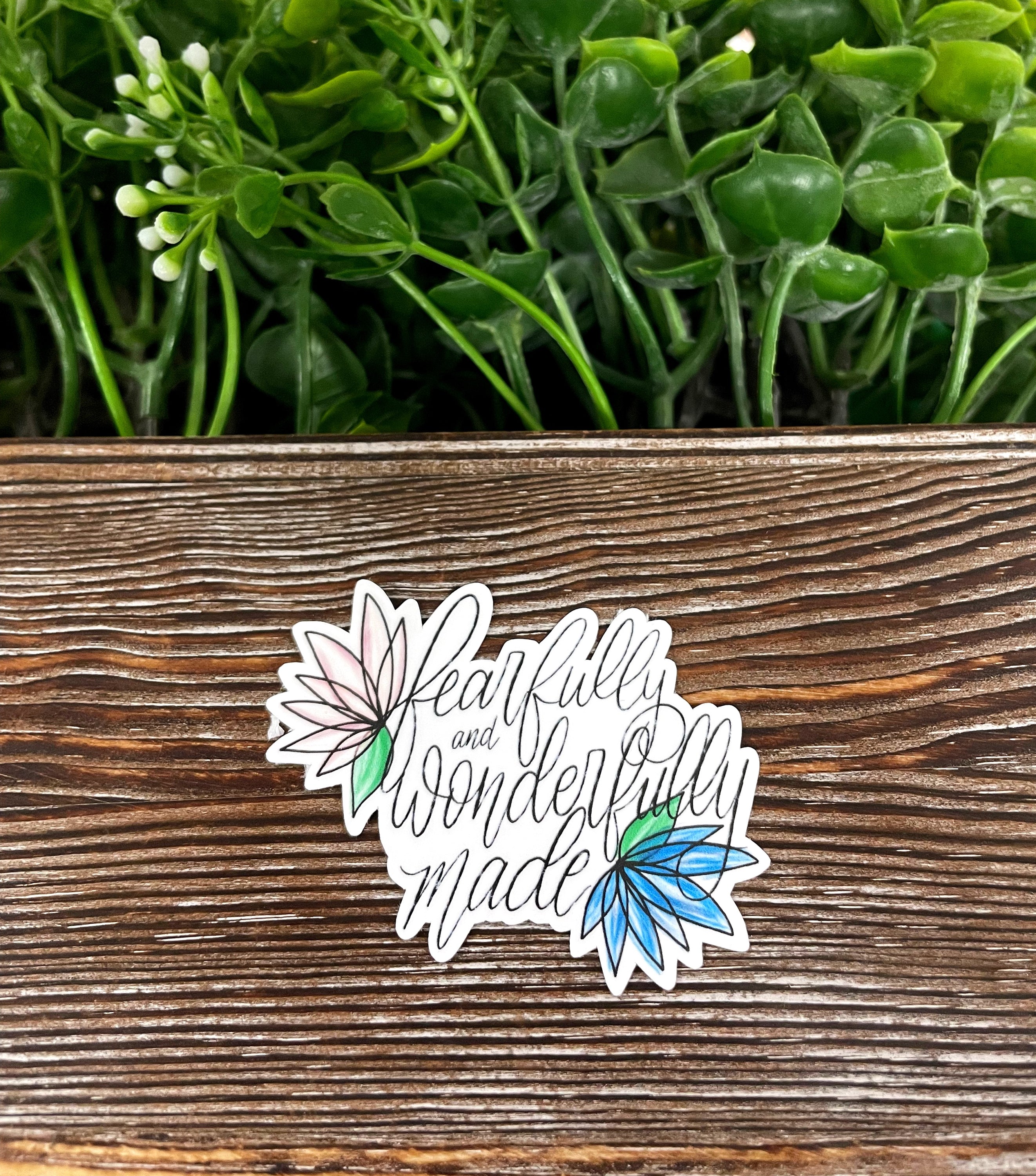 Fearfully and Wonderfully Made die cut sticker on a smooth surface, showcasing vibrant colors and intricate design.