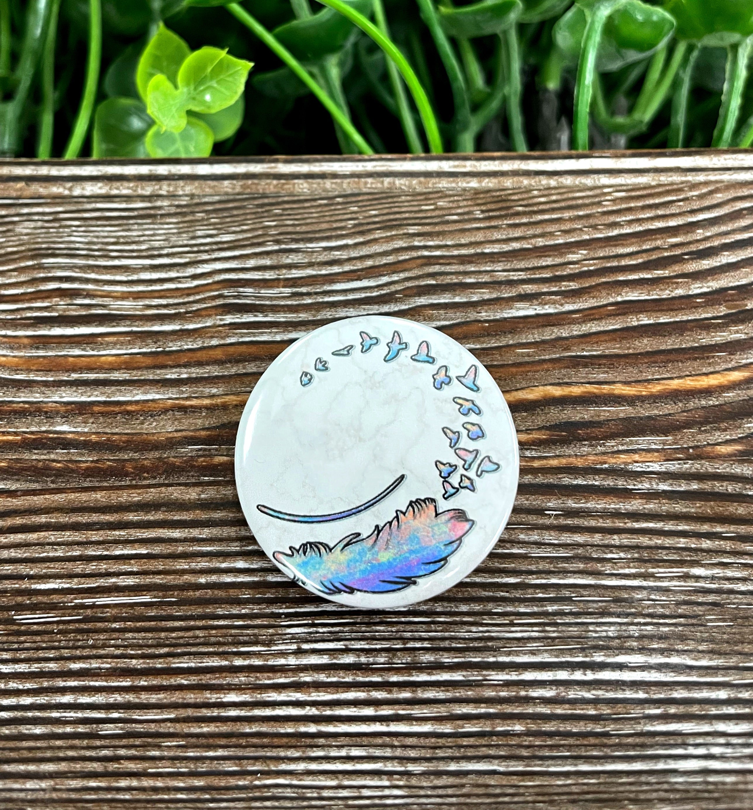 Feather into Birds Graphic Art Button, 1.25 inches, featuring a colorful feather design transitioning into birds.