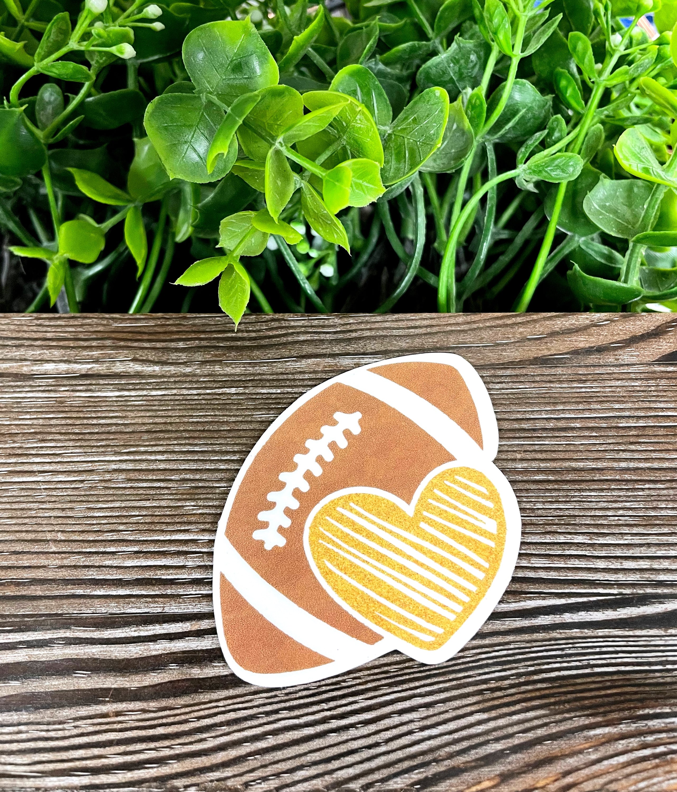 A vibrant Football and Heart Sticker featuring a football and heart design, perfect for personalizing various surfaces.