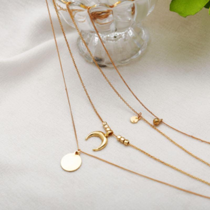 A beautiful four-layer golden necklace made of high-quality zinc alloy, showcasing an elegant design suitable for various occasions.